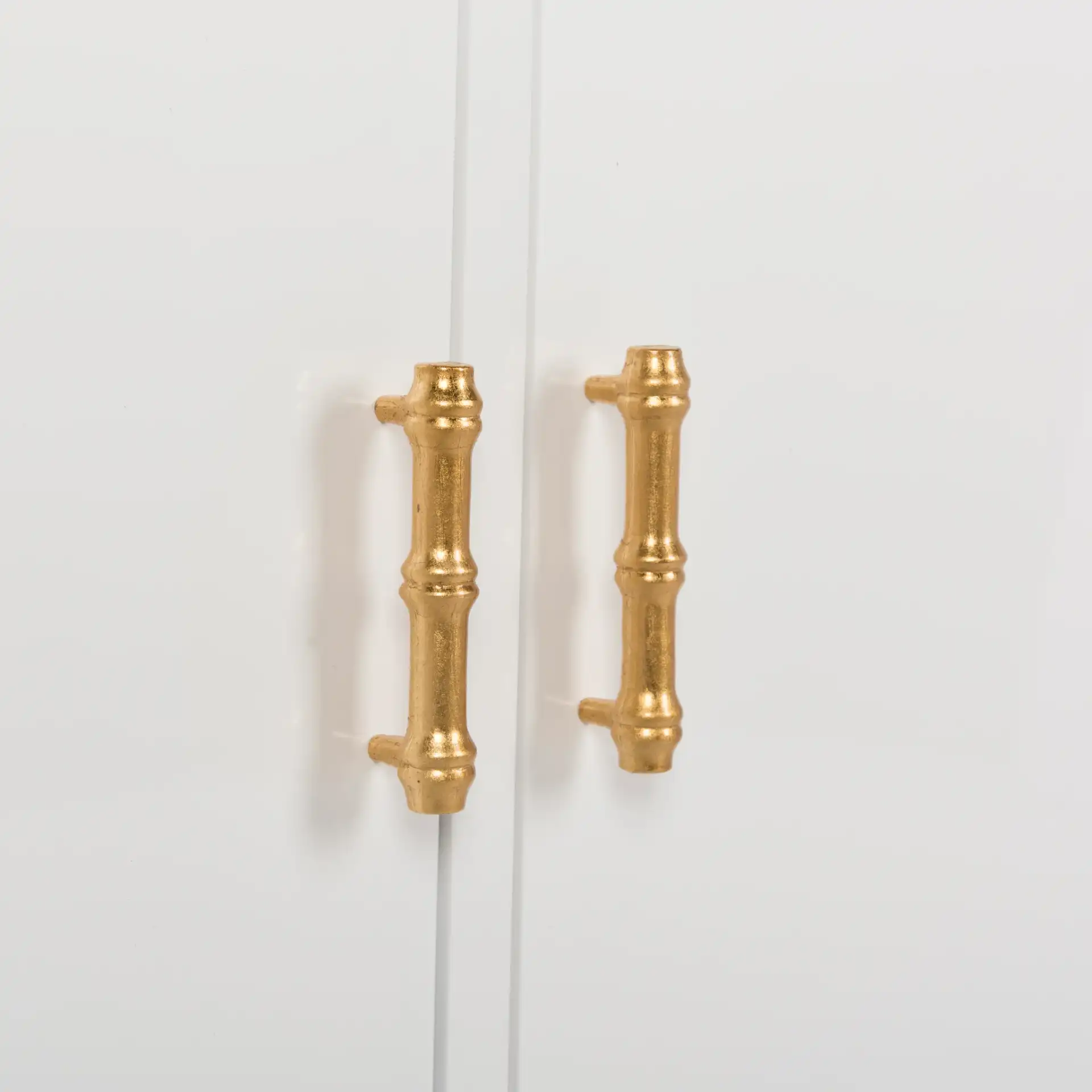 Adelia Bookshelf in White / Gold in a styled room