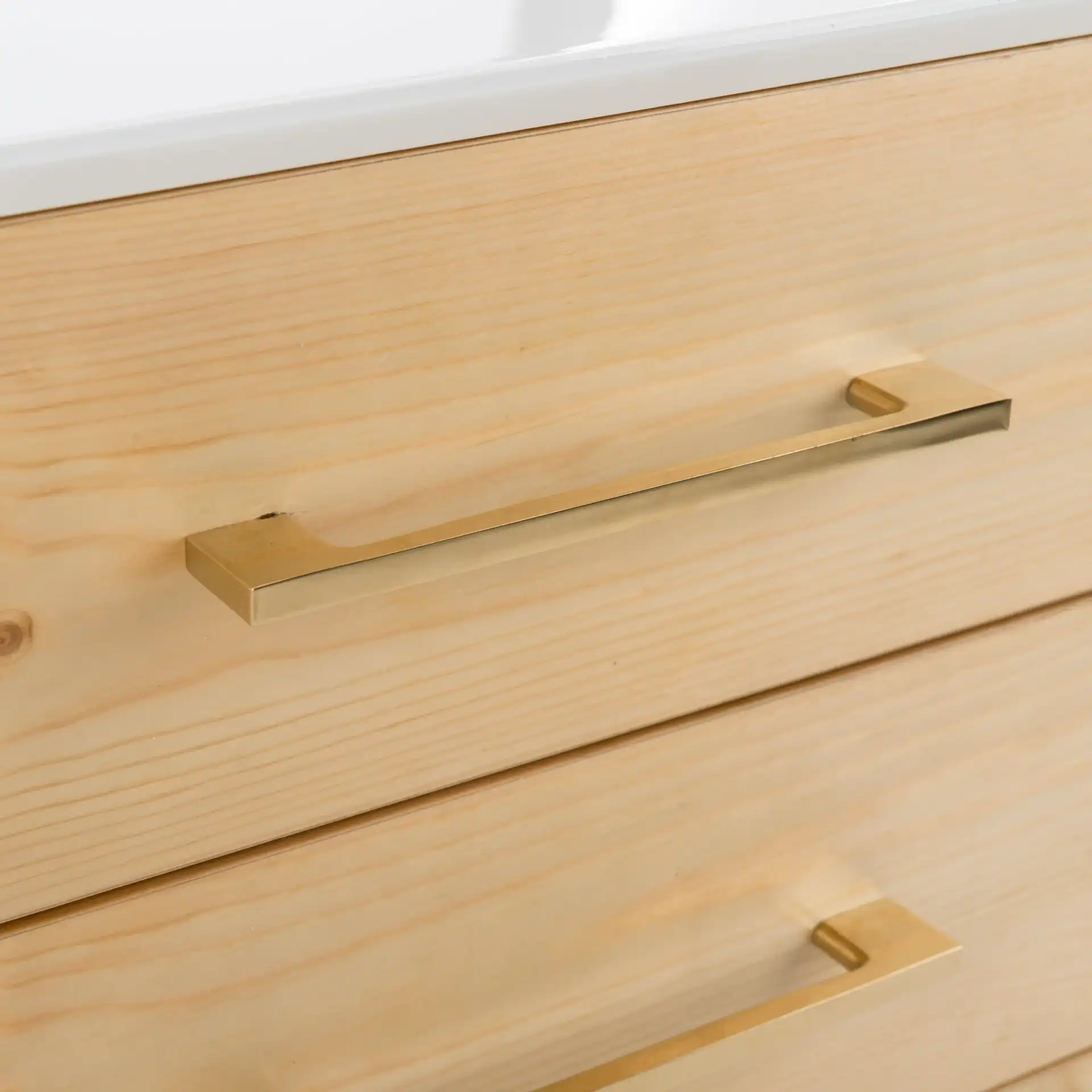 Vanda Three-Drawer Side Table in White in a styled room