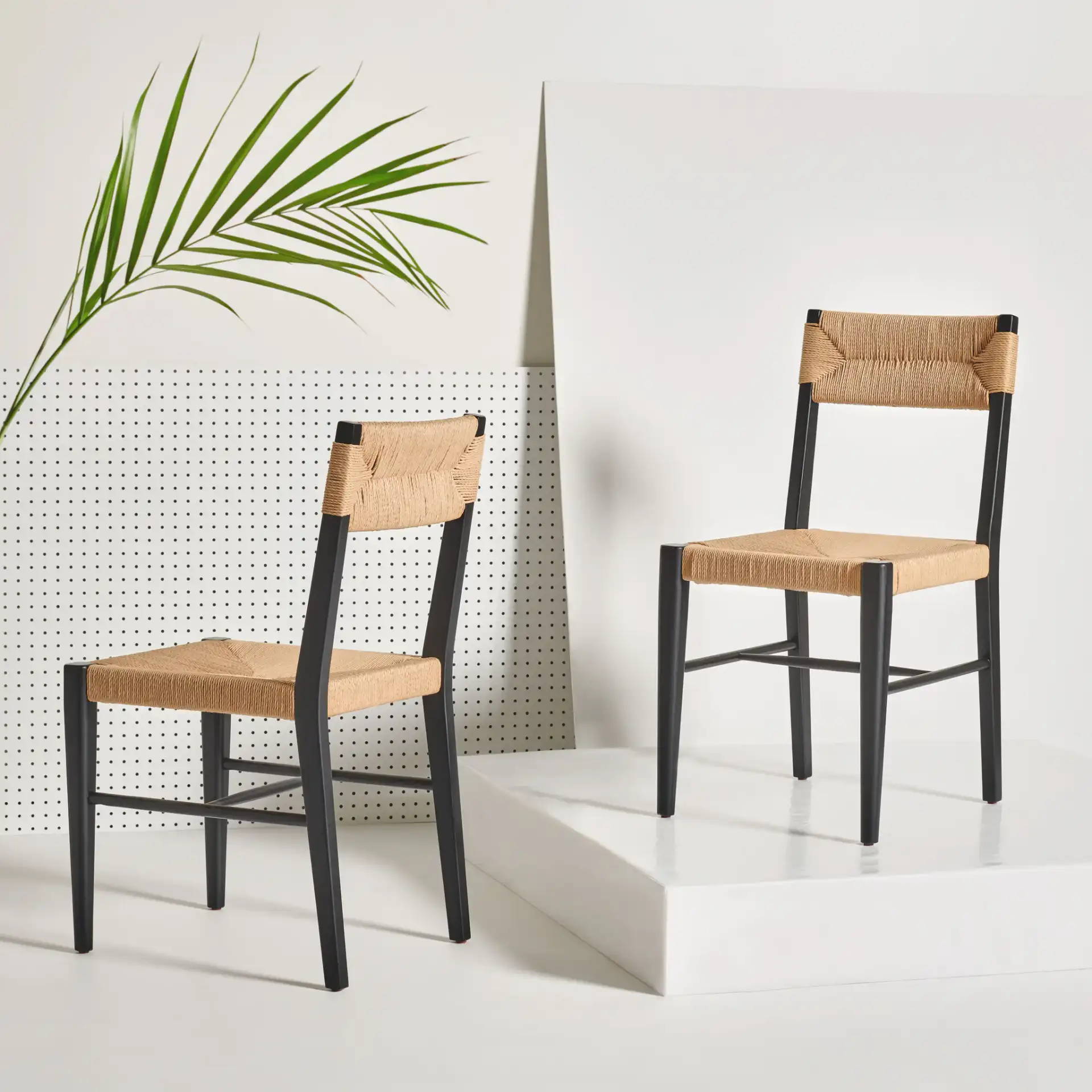 Cody Rattan Dining Chair (Set of 2) in Black / Natural in a styled room