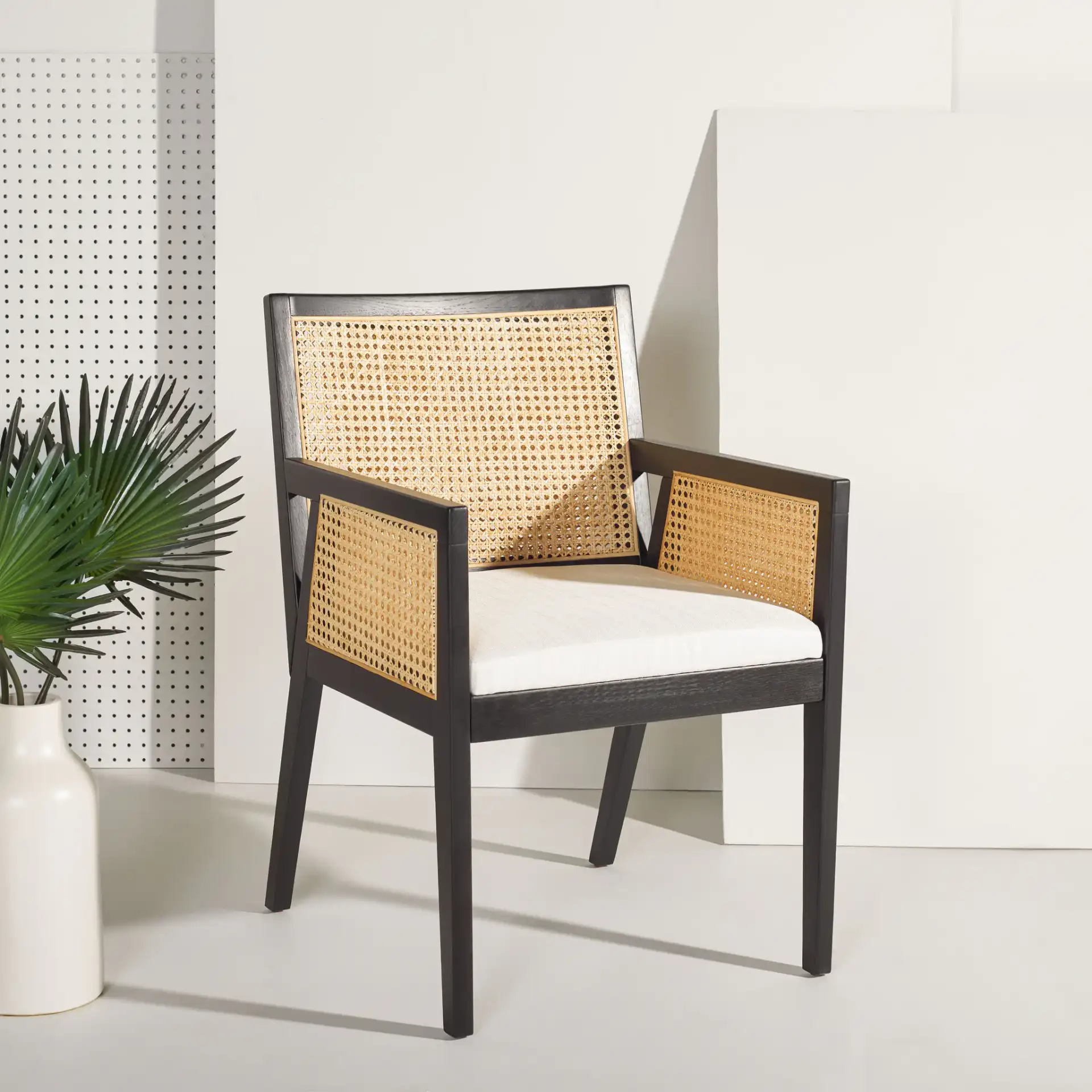 Malik Rattan Dining Chair in Black / Natural in a styled room