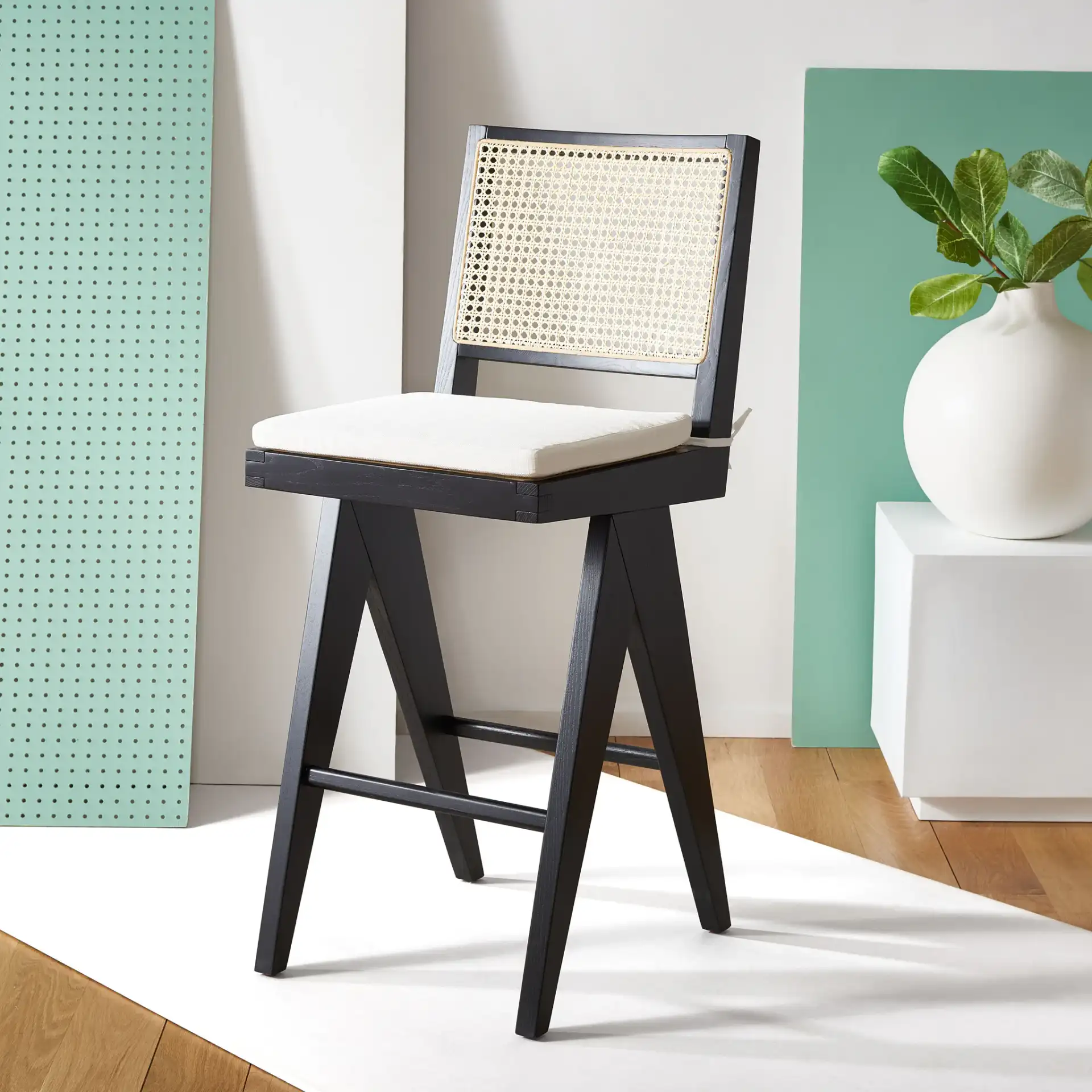 Colette Rattan Barstool in Black / Natural in a styled room
