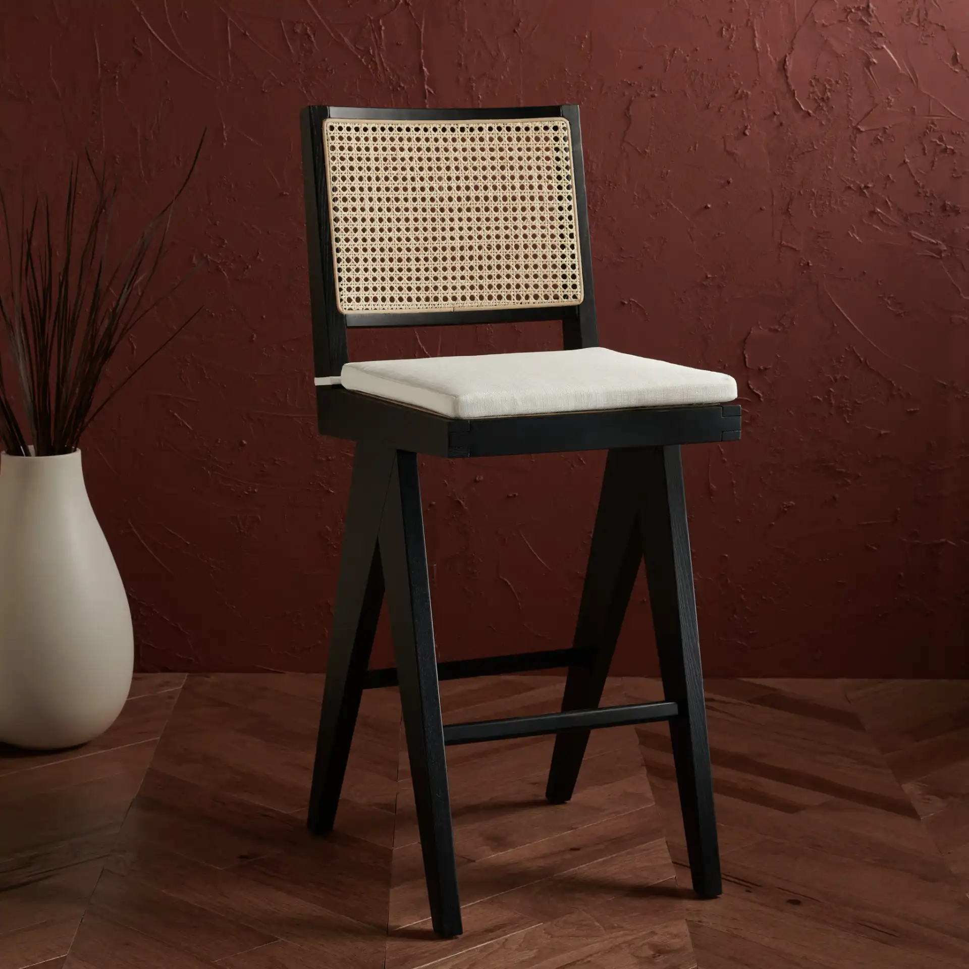 Colette Rattan Barstool in Black / Natural in a styled room