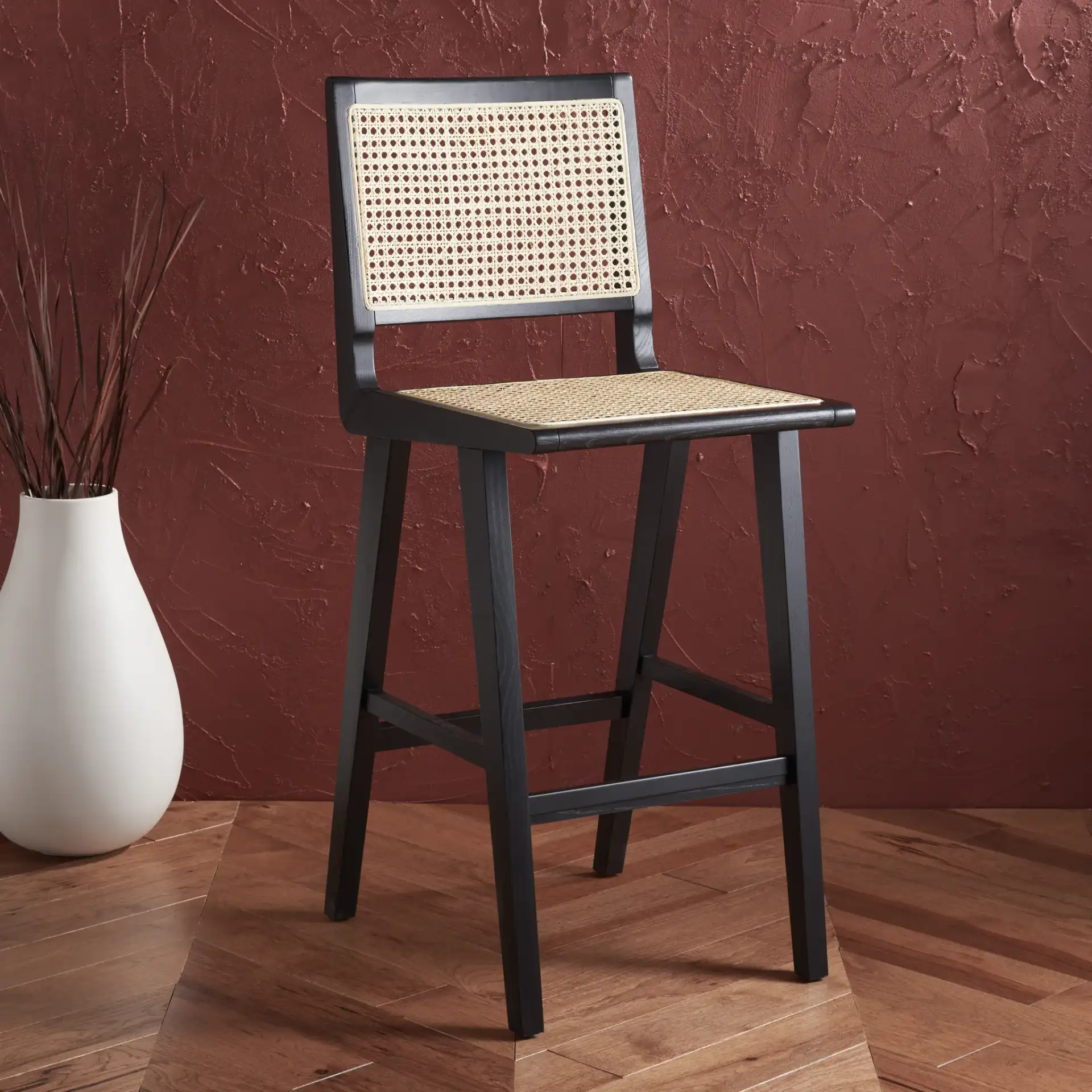 Hattie French Cane Barstool in Black / Natural in a styled room