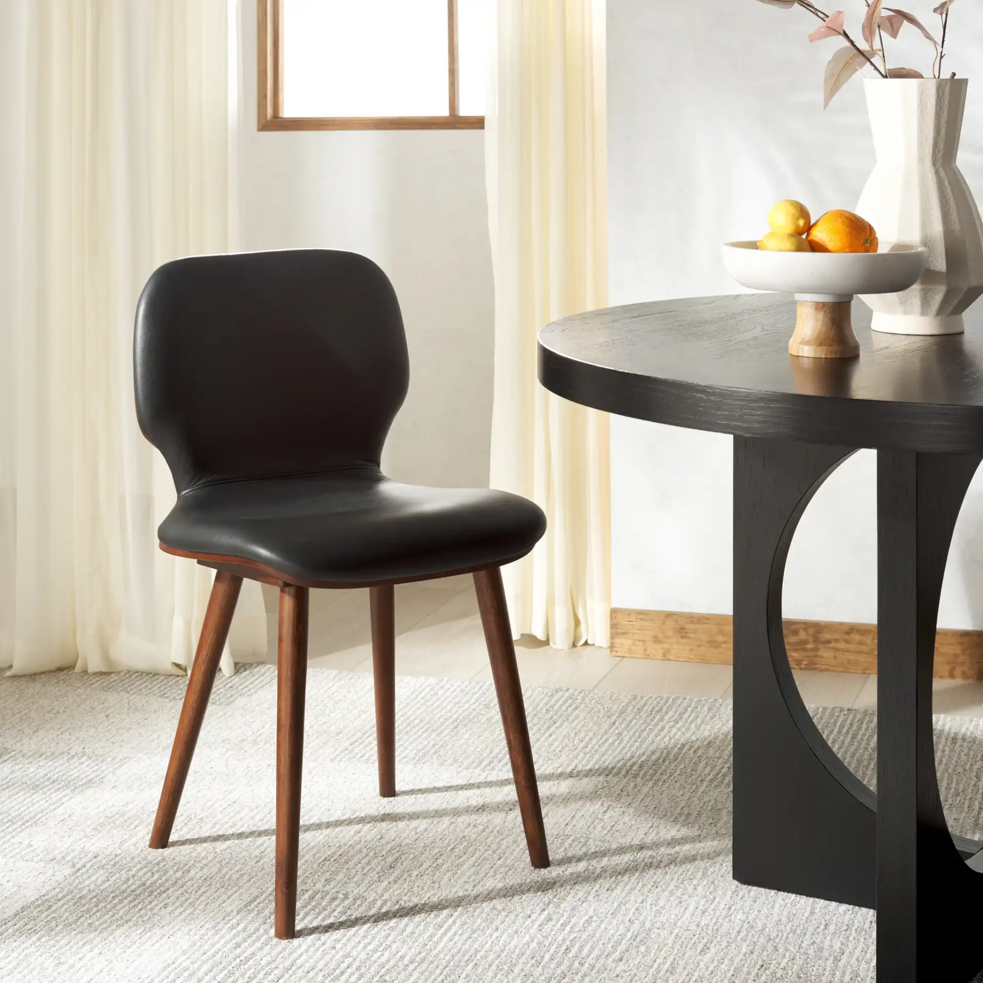 Tazmyn Dining Chair in Black / Walnut in a styled room