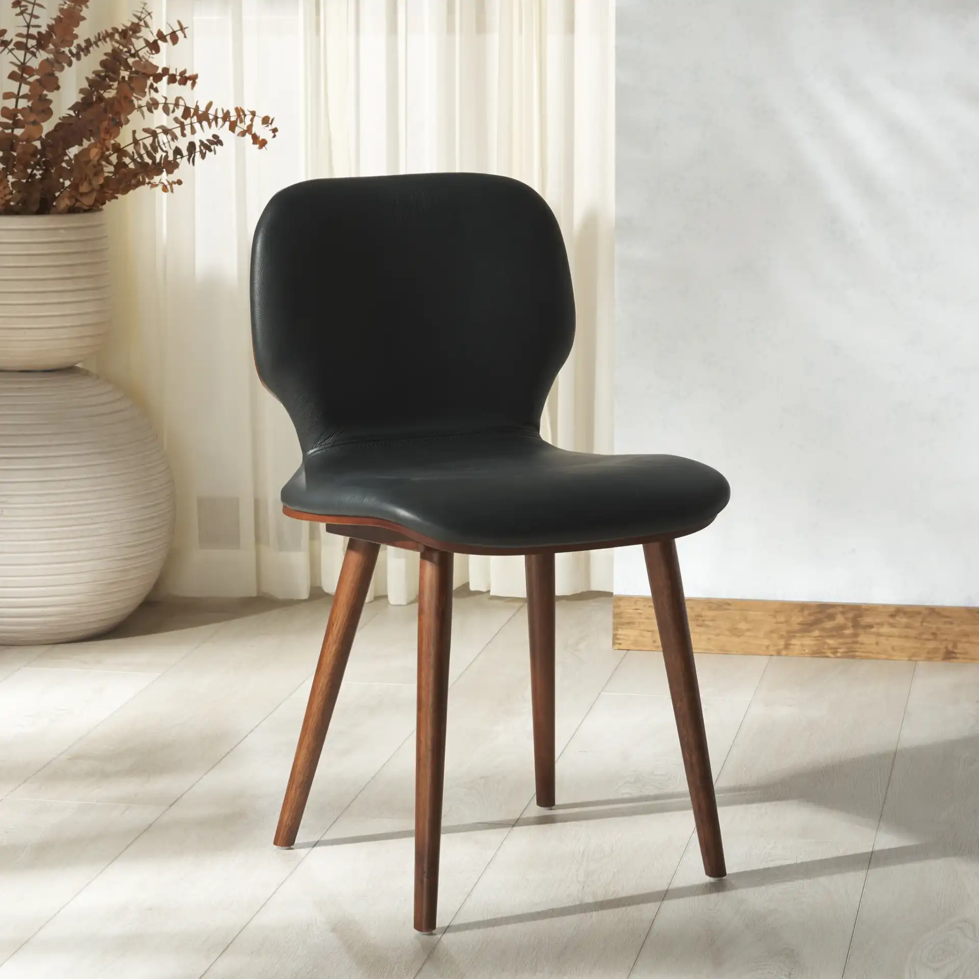 Tazmyn Dining Chair in Black / Walnut in a styled room