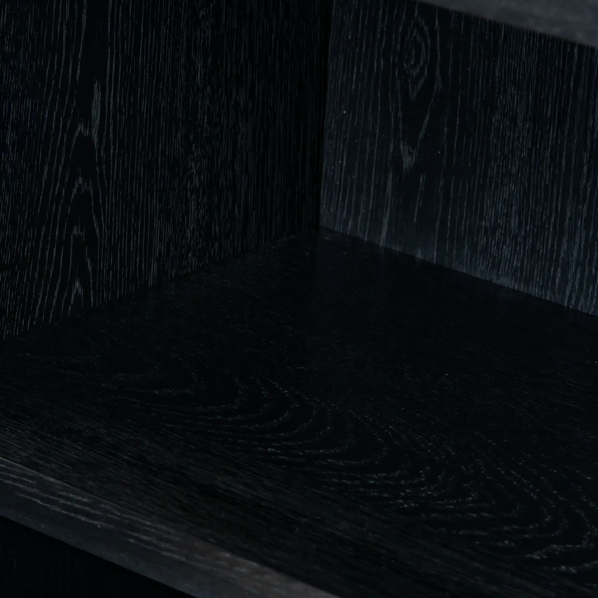 Zeus Four-Shelf Wood Bookcase in Black in a styled room