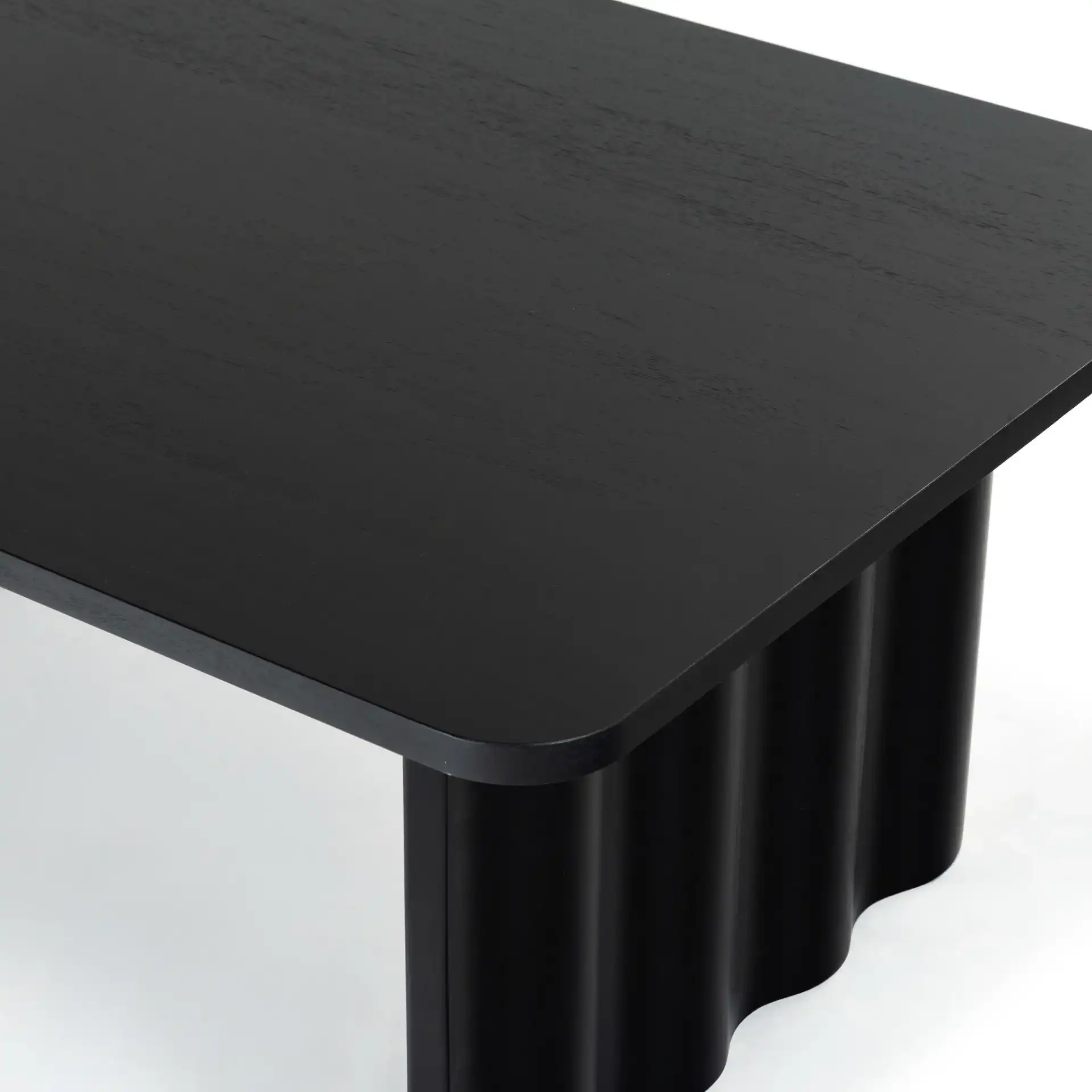 Yurina Rectangular Wood Coffee Table in Black in a styled room