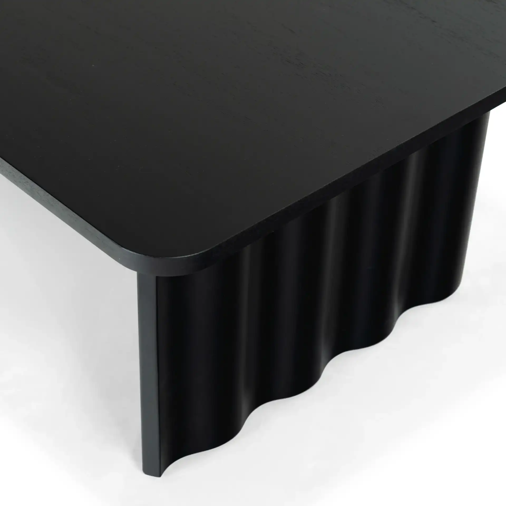 Yurina Rectangular Wood Coffee Table in Black in a styled room