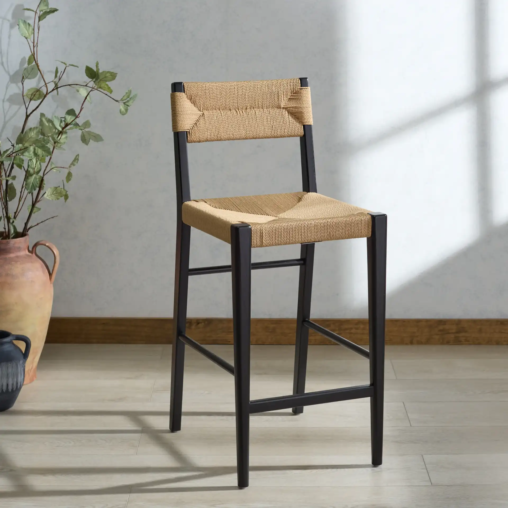 Cody Rattan Counter Stool in Black / Natural in a styled room