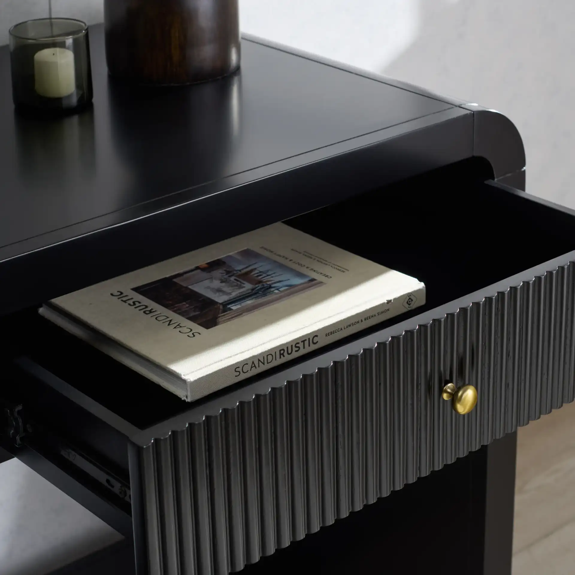 Liabella Two-Drawer Curved Desk in Black in a styled room