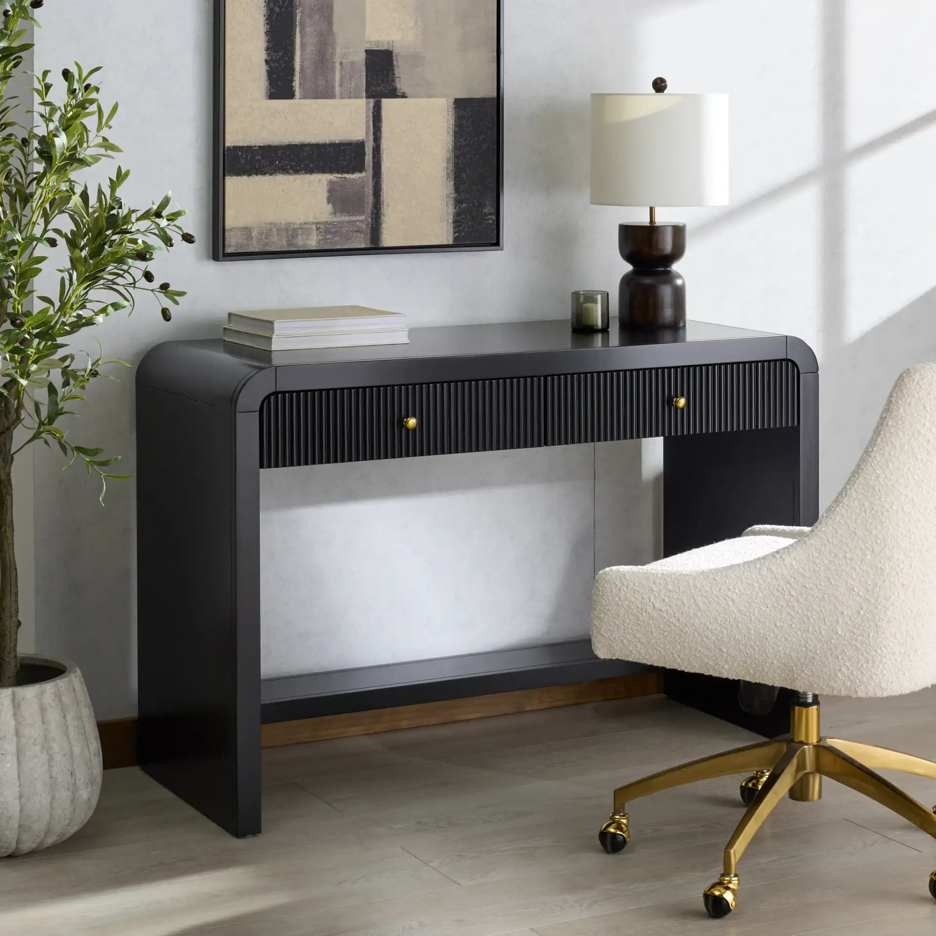 Liabella Two-Drawer Curved Desk in Black in a styled room