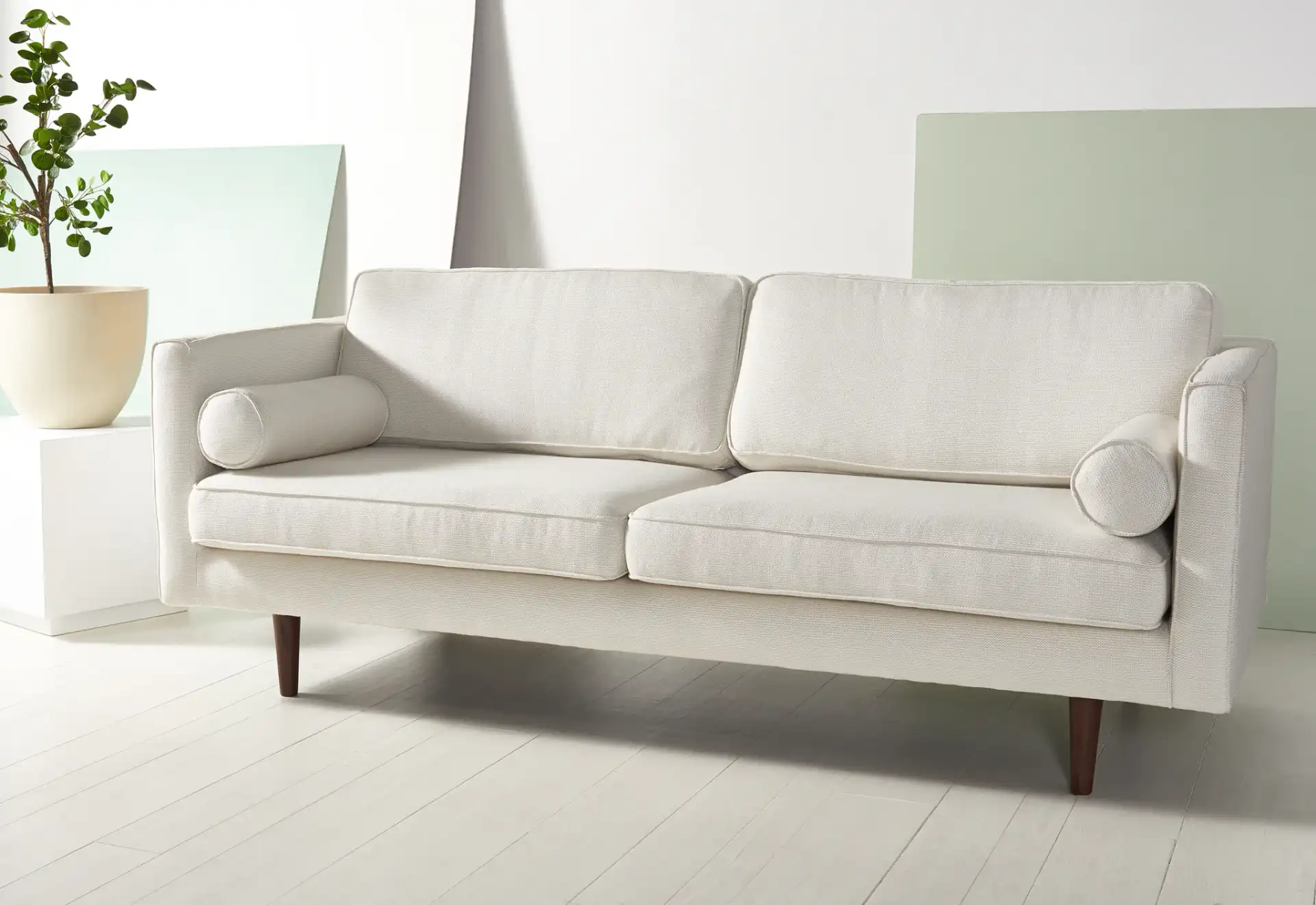 Hurley Mid-Century Sofa in White in a styled room