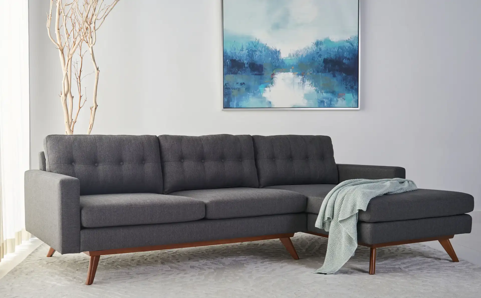 Gneiss Modern Sectional Sofa in Slate / Grey in a styled room