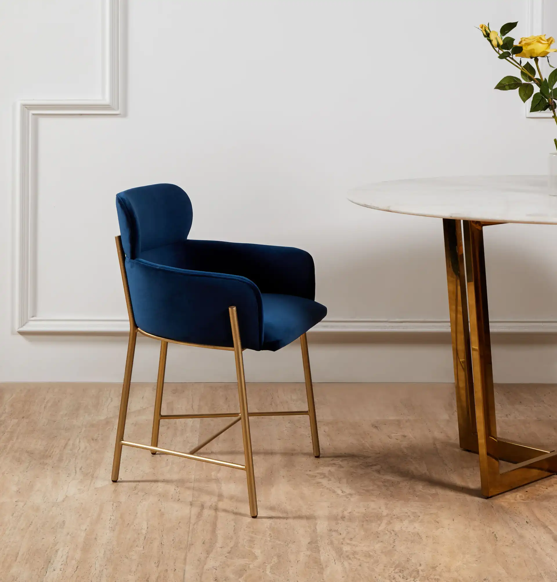 Charlize Velvet Dining Chair in Navy / Gold in a styled room