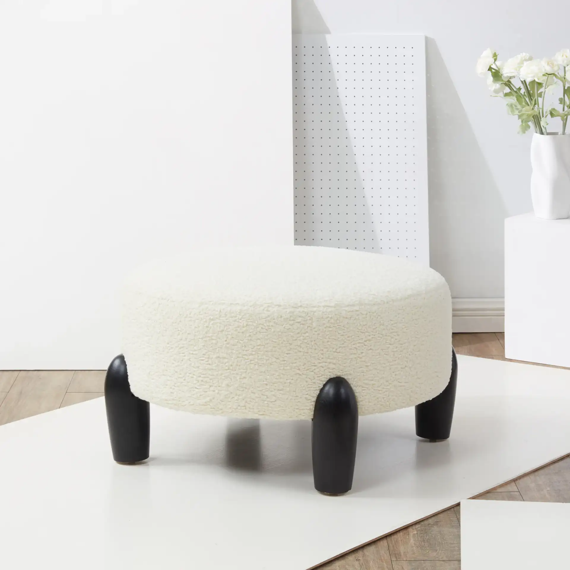 Perez Scandinavian Round Ottoman in Ivory / Natural in a styled room