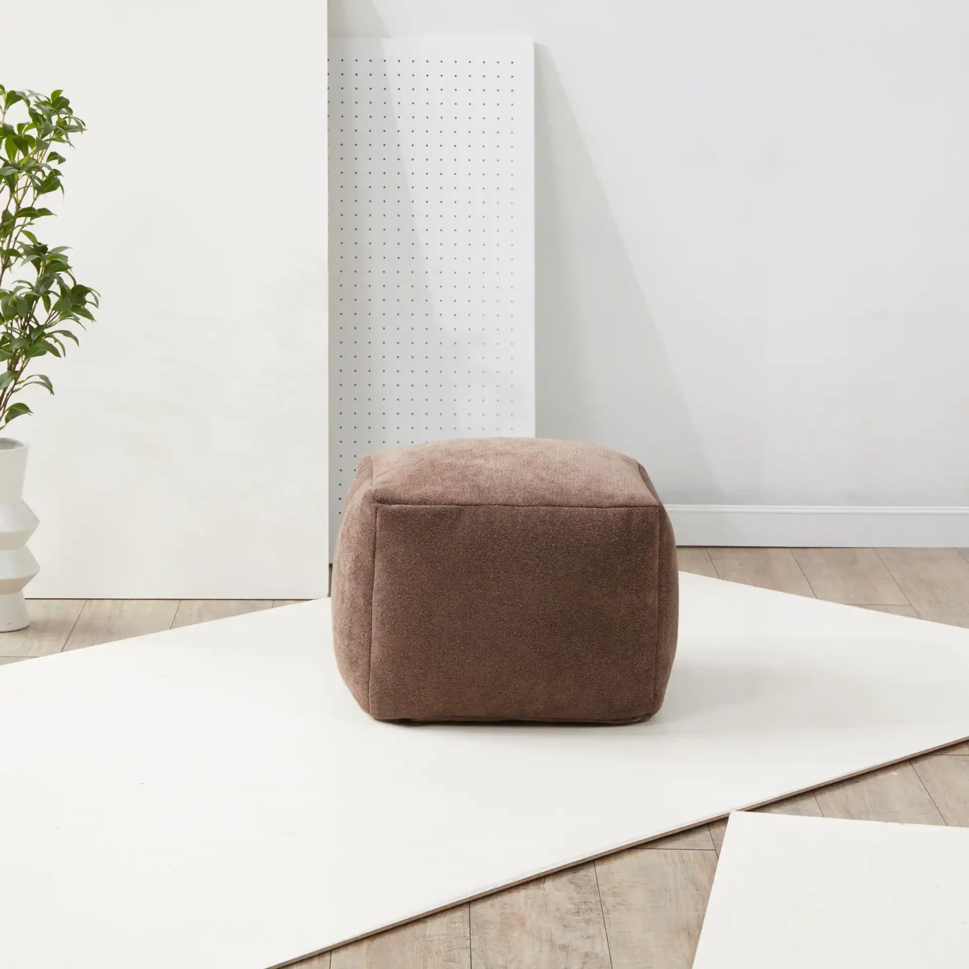 Samuels Boucle Pouf in Dark Brown in a styled room