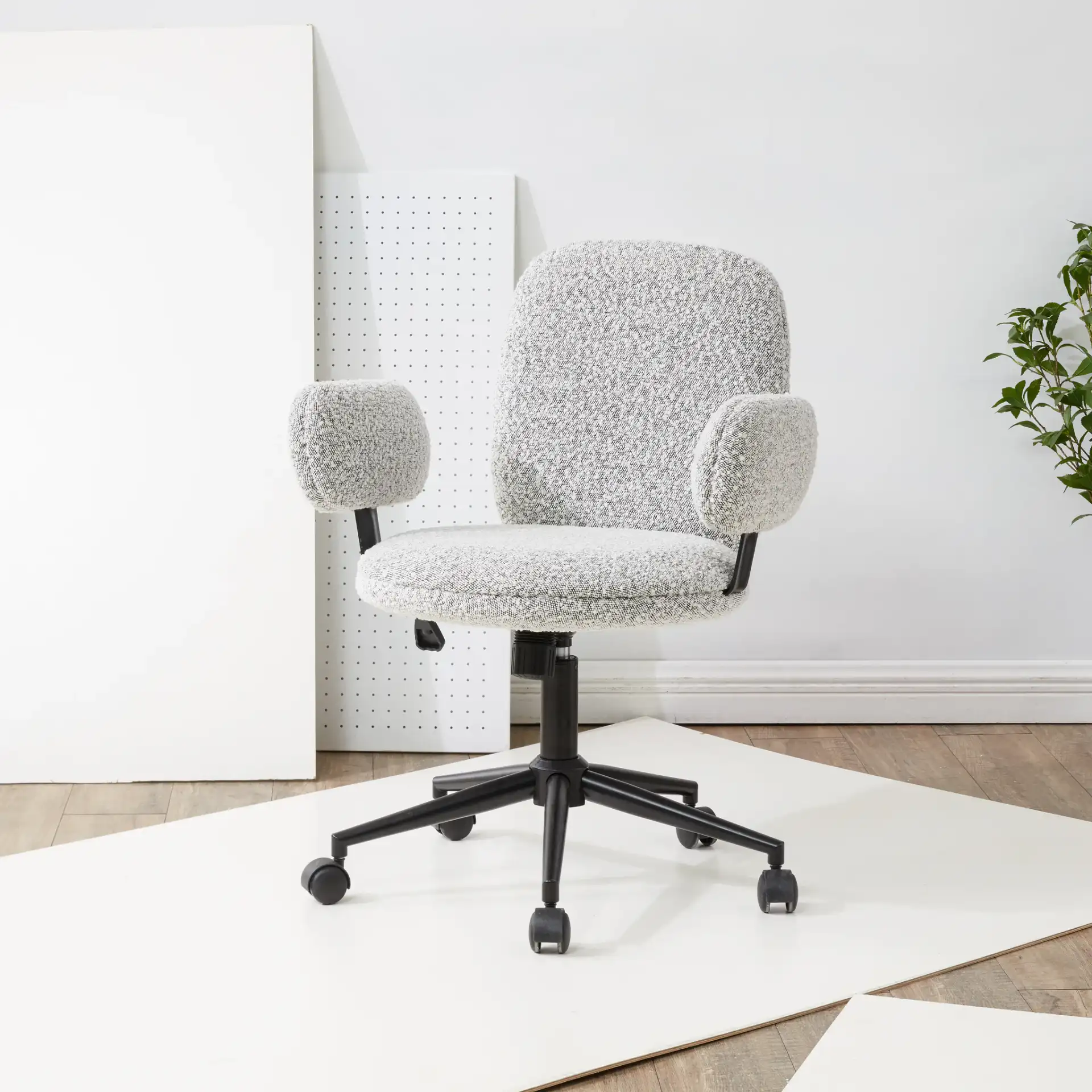 Emeril Adjustable Desk Chair in White / Black in a styled room