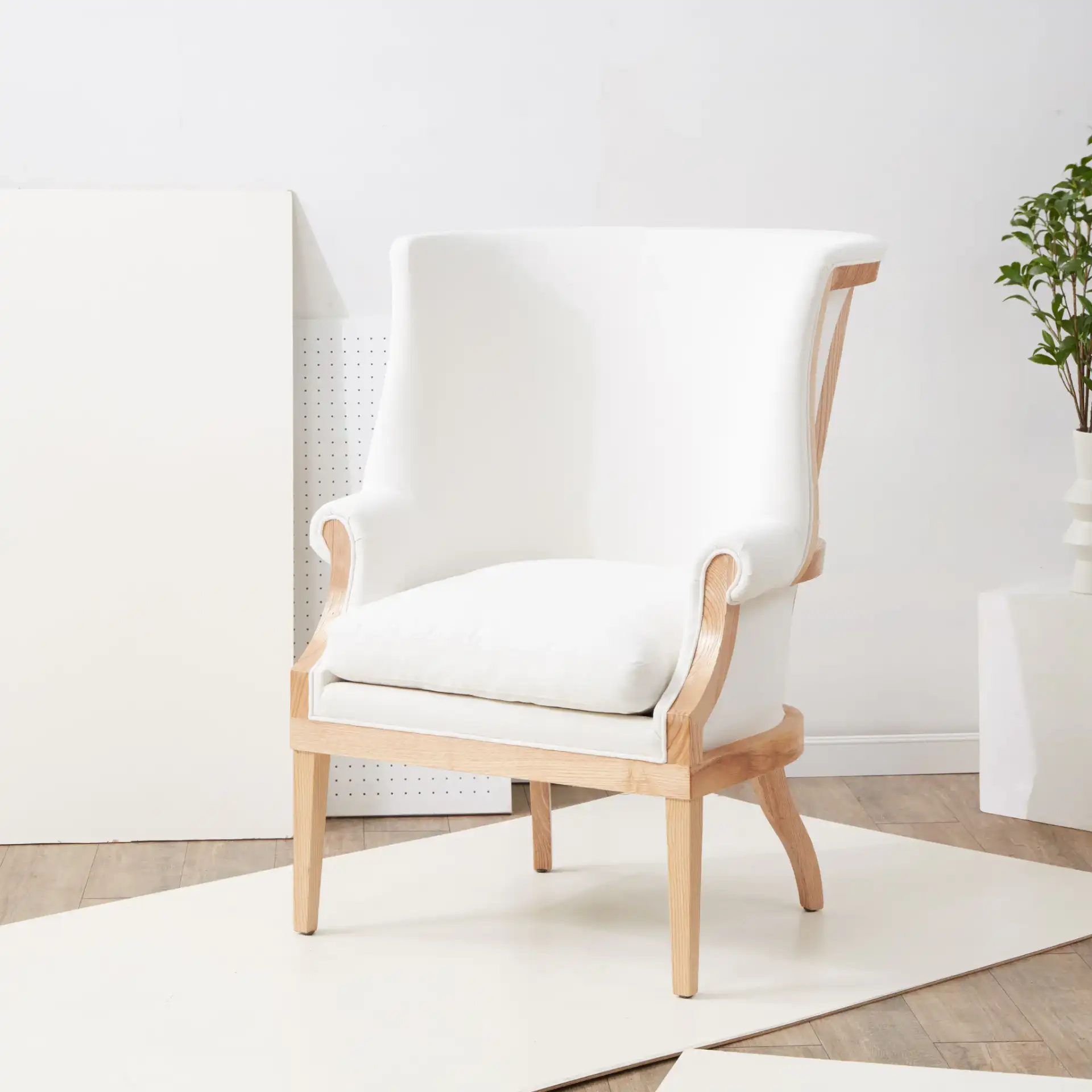Leahbeth Wingback Accent Chair in White / Natural in a styled room
