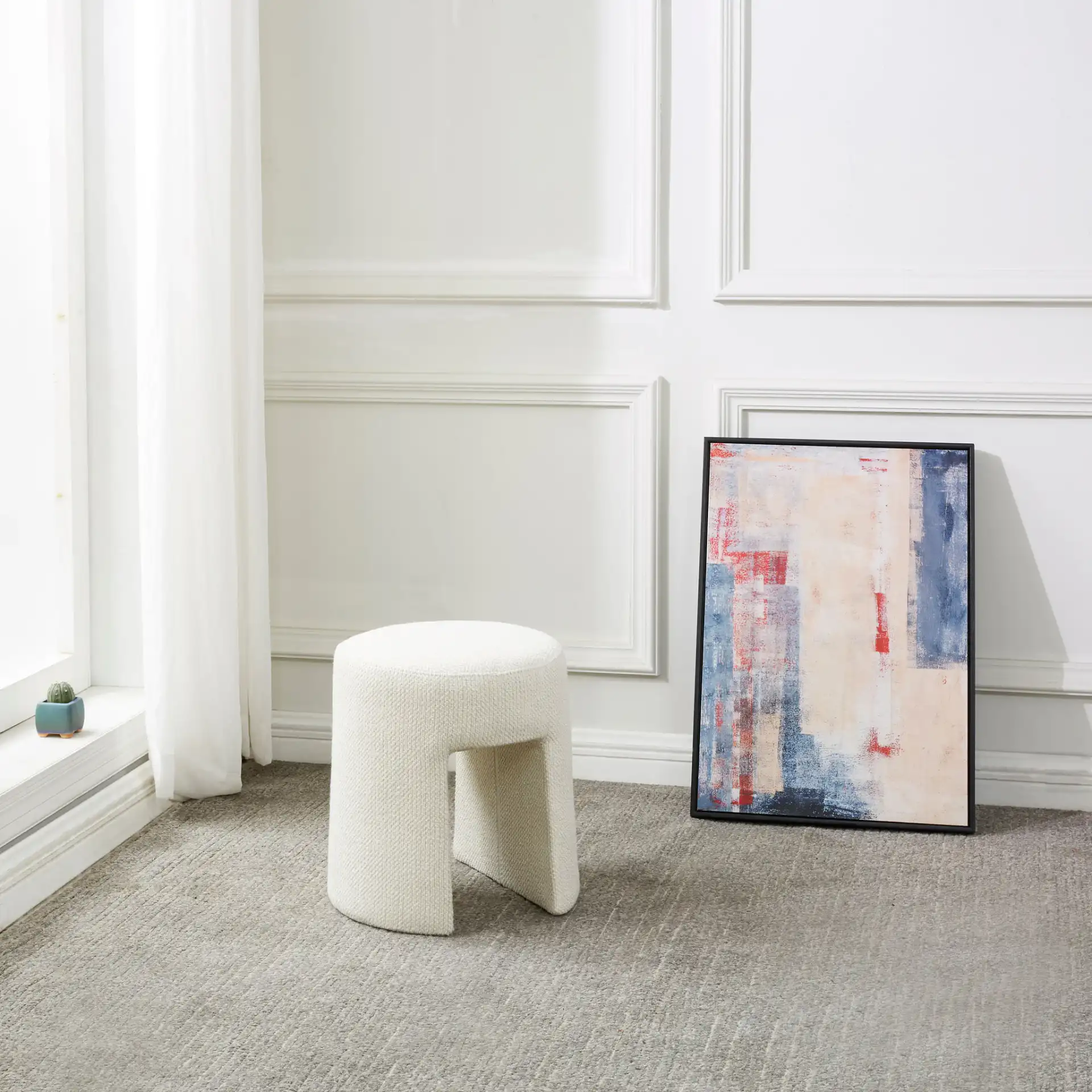Ginny Upholstered Ottoman in Ivory in a styled room