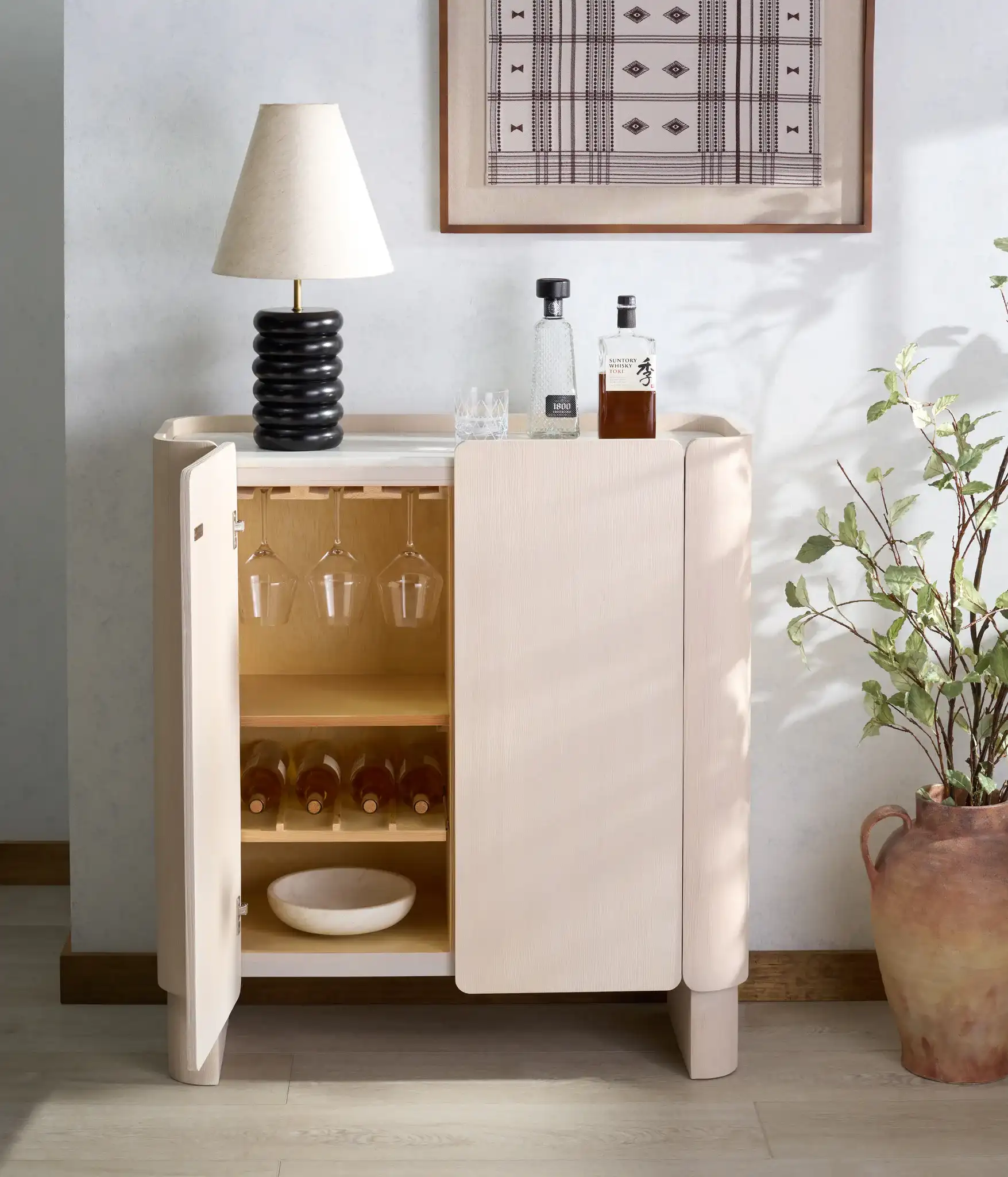 Alanabella Marble Bar Cabinet in Sand / White in a styled room