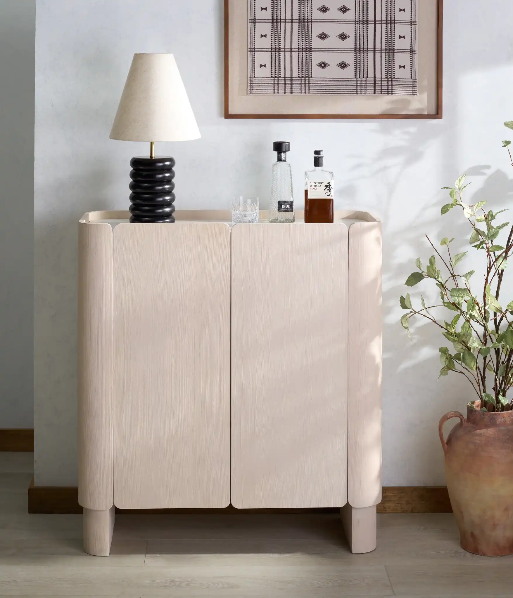 Alanabella Marble Bar Cabinet in Sand / White in a styled room