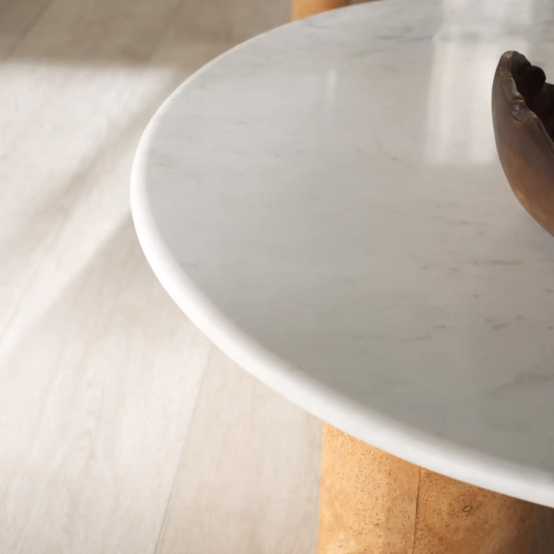 Marilynn Cork Coffee Table in White / Cork in a styled room