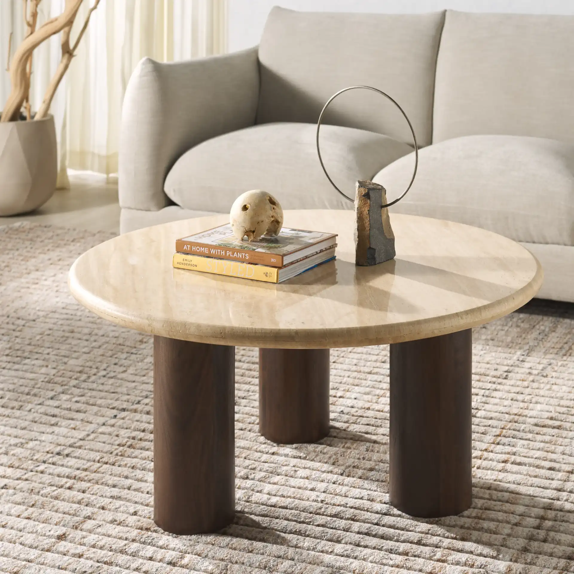 Jennamira Travertine Coffee Table in Dark Brown / Travertine in a styled room