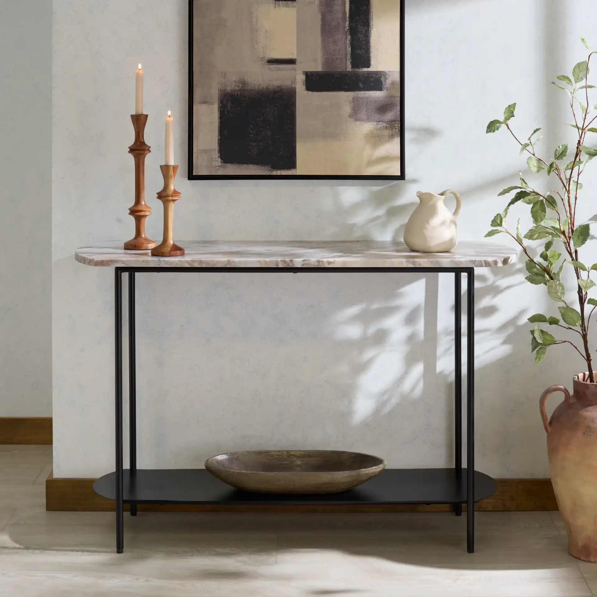 Macklyn Oval Console Table in Light Brown / Black in a styled room
