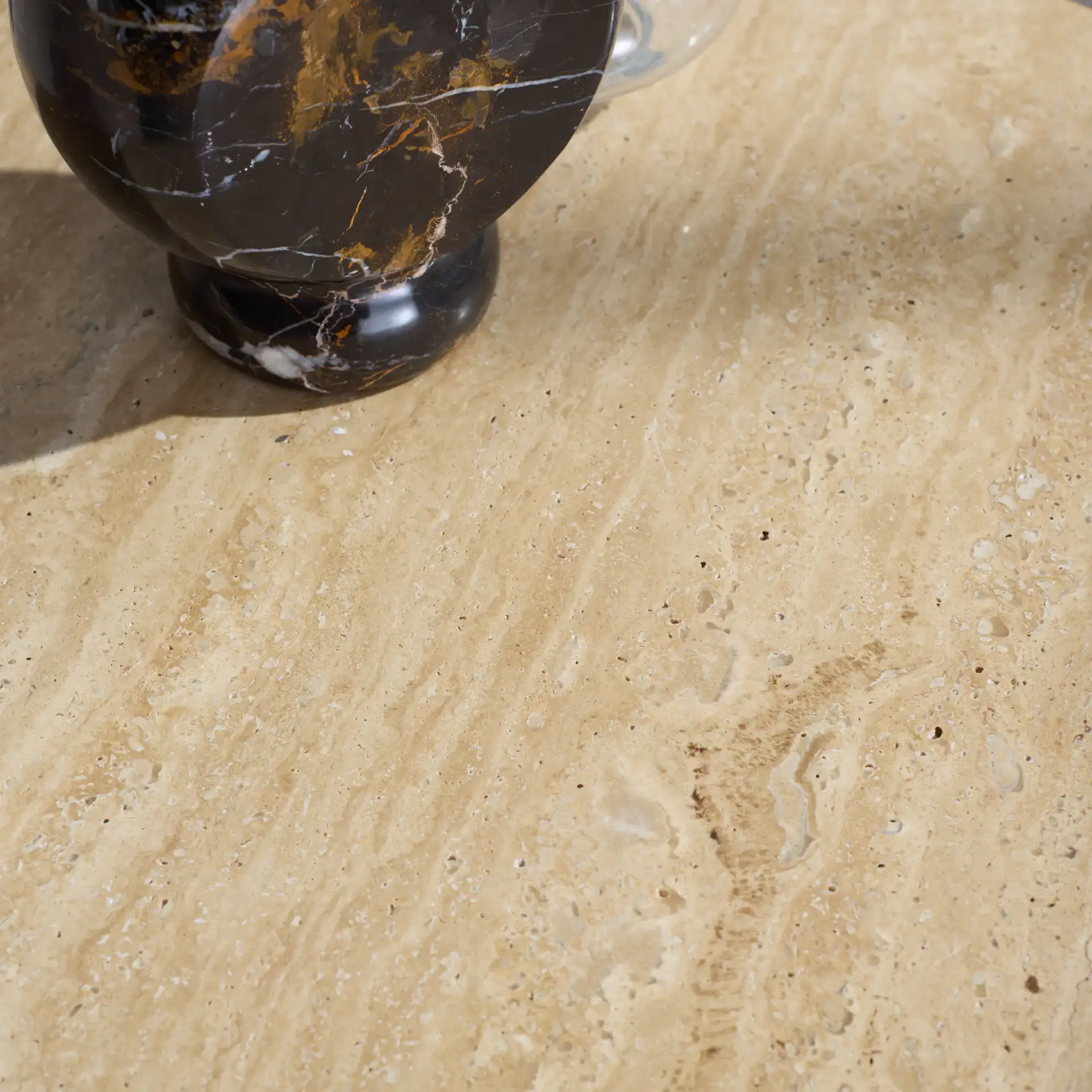 Jennamira Travertine Accent Table in Natural / Travertine in a styled room
