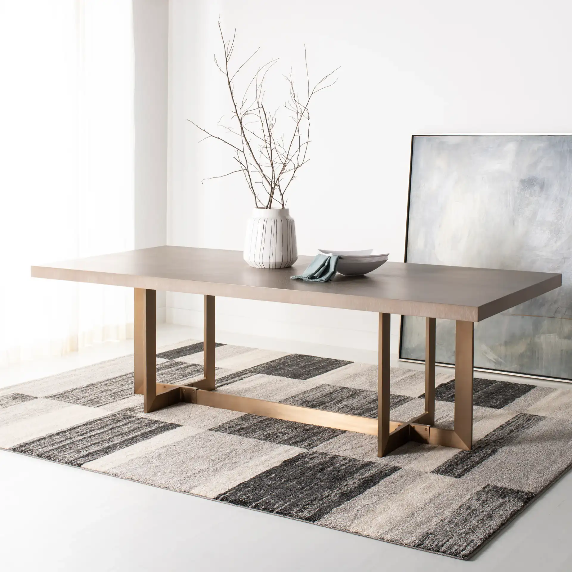 Quinn Dining Table in Gray Oak / Brass in a styled room