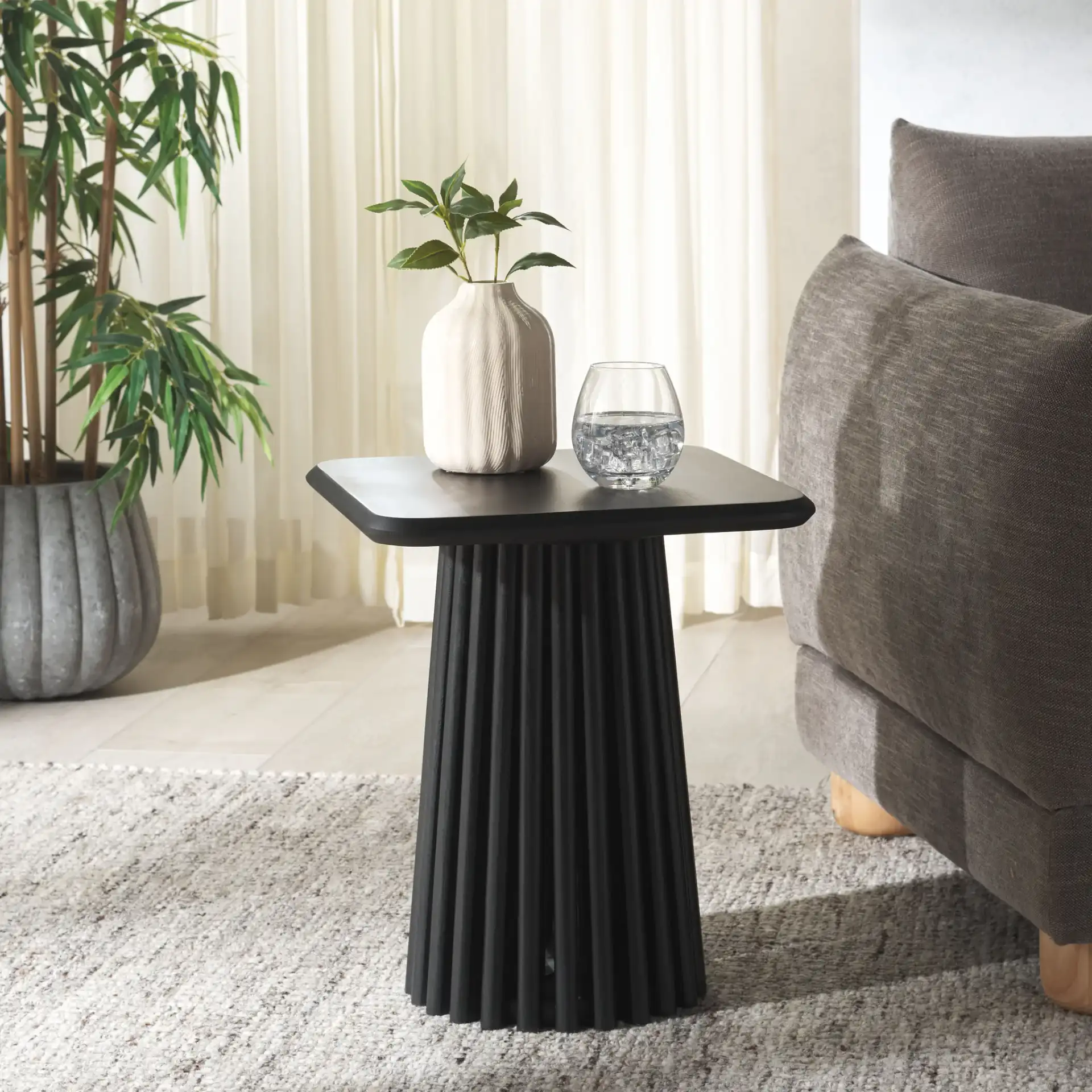Penelope Wood Accent Table in Black in a styled room