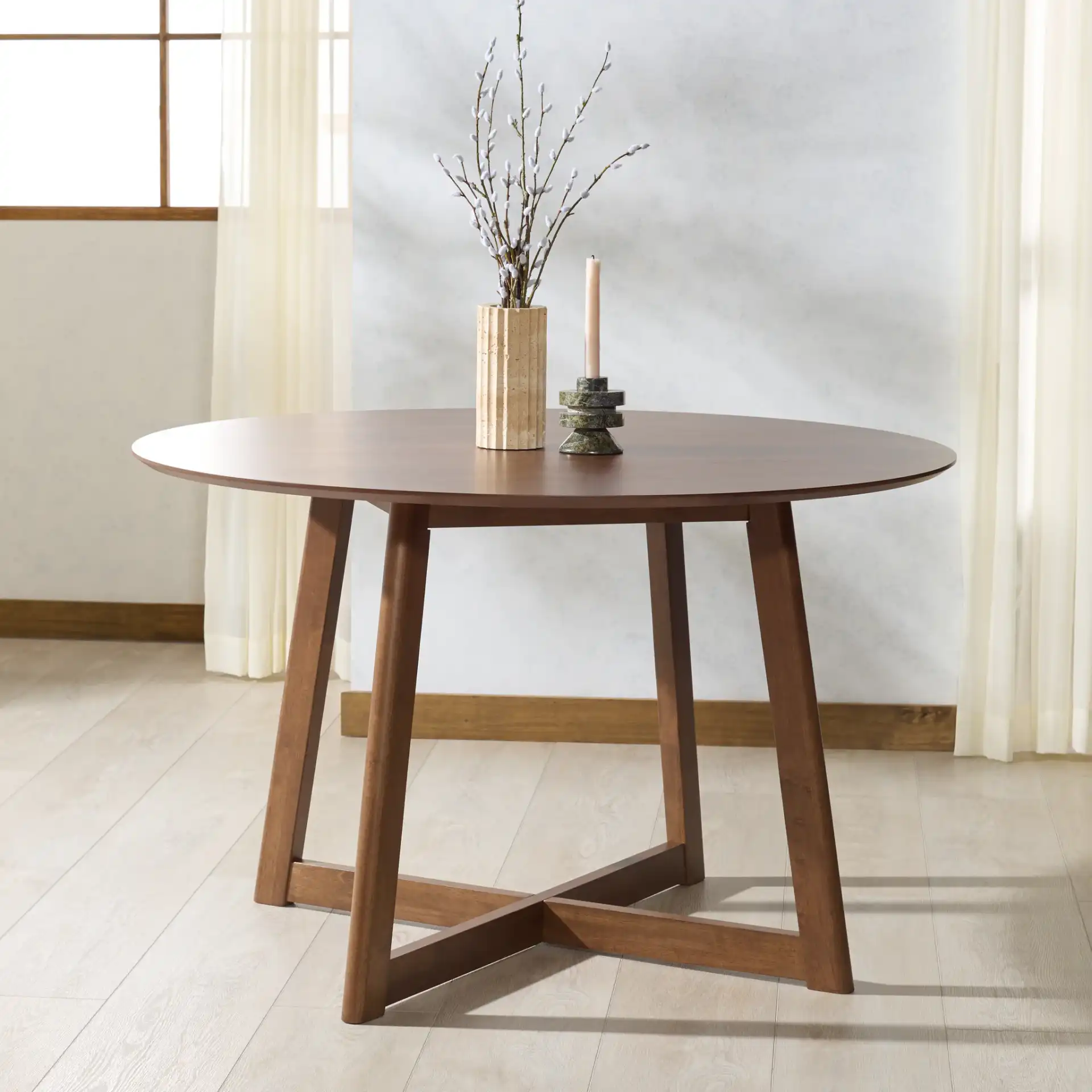 Jessbrina Round Wood Dining Table in Walnut in a styled room