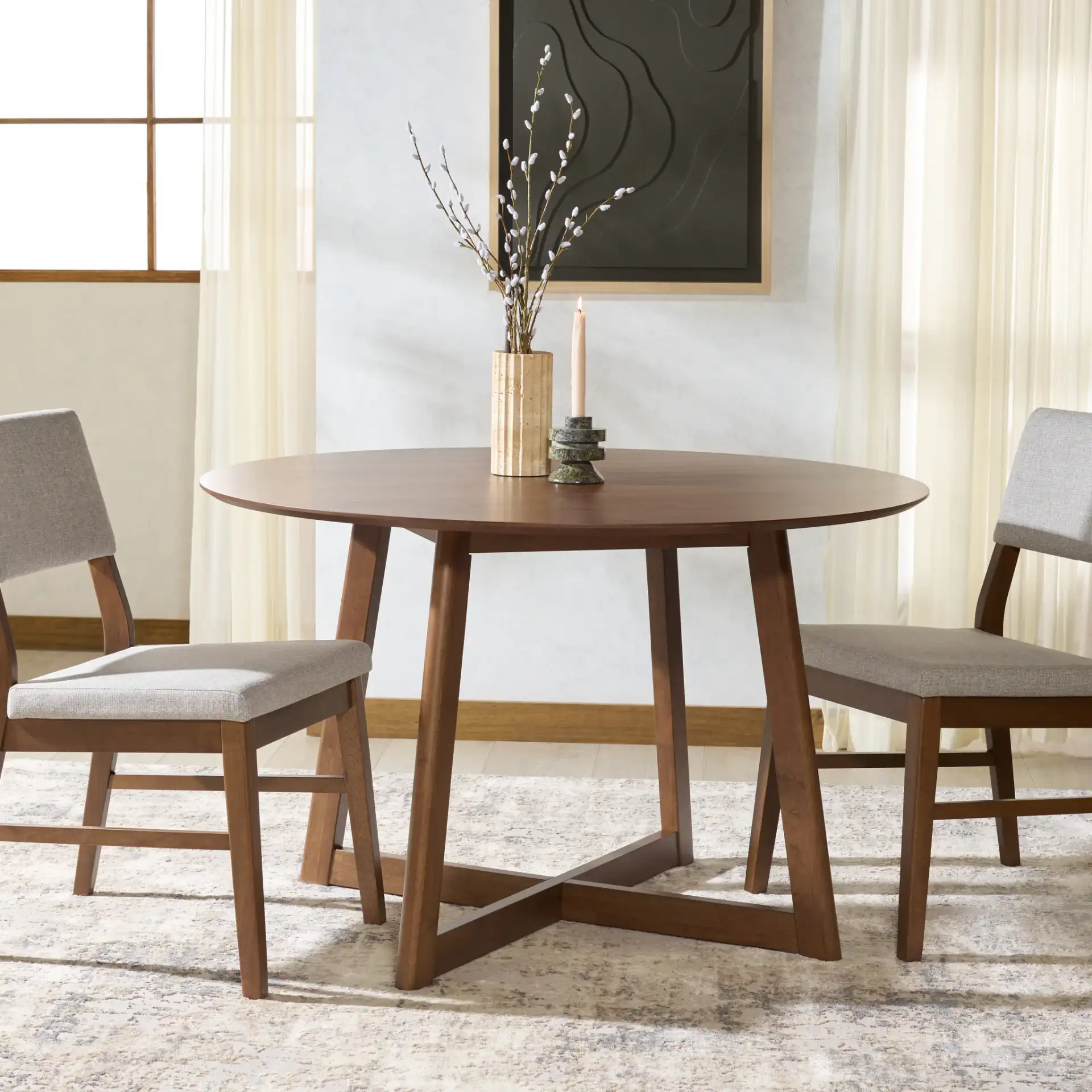 Jessbrina Round Wood Dining Table in Walnut in a styled room