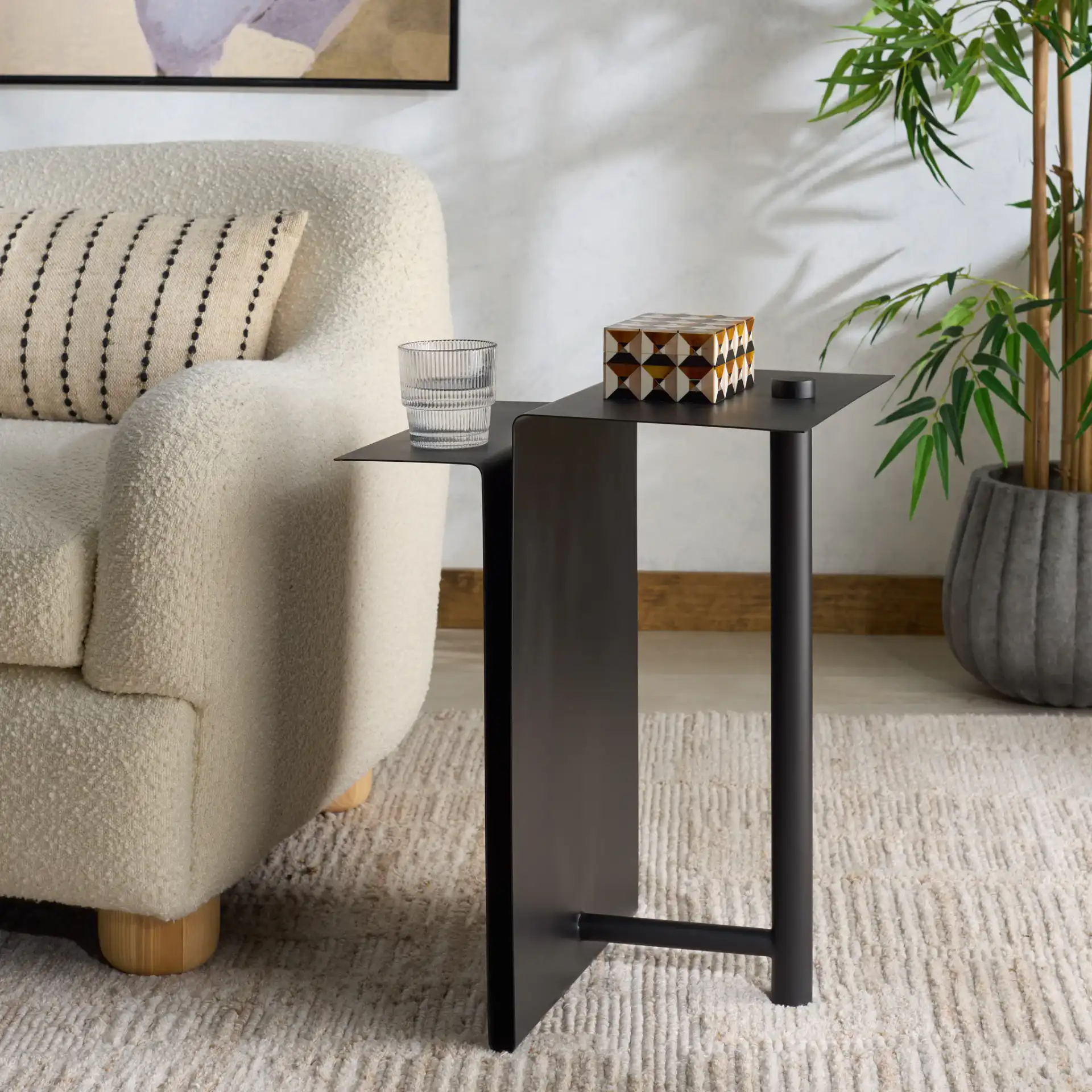 Aldwyn Metal Accent Table in Black in a styled room