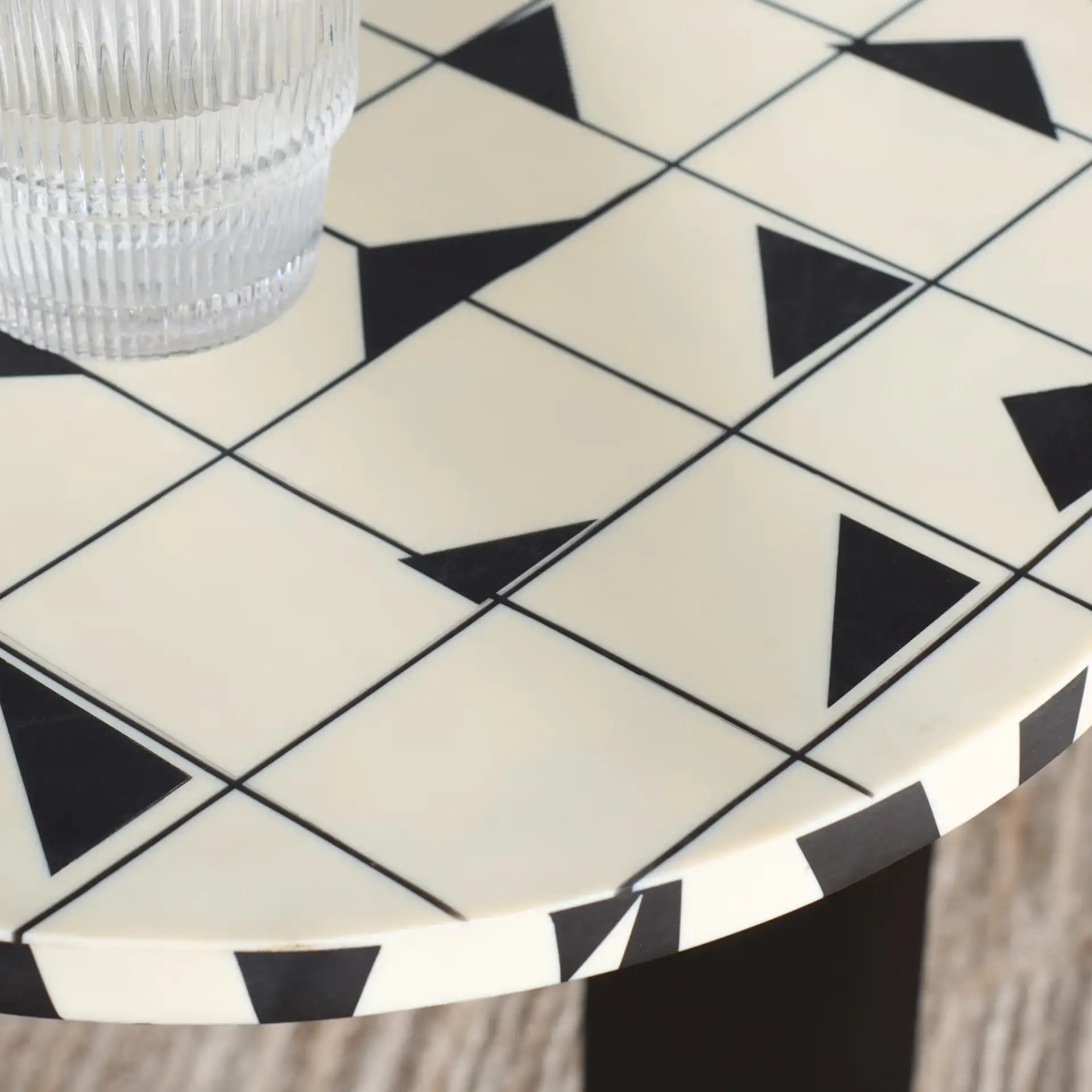 Tomlinson Resin Top Accent Table in Black / White in a styled room