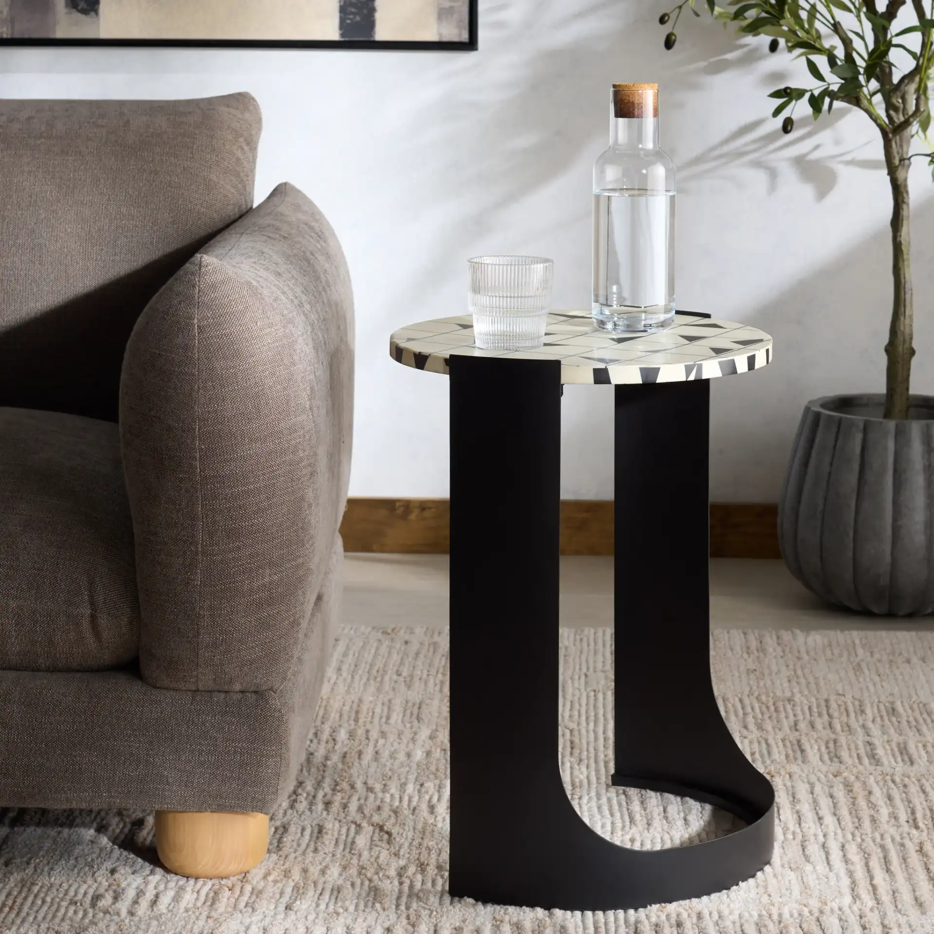 Tomlinson Resin Top Accent Table in Black / White in a styled room