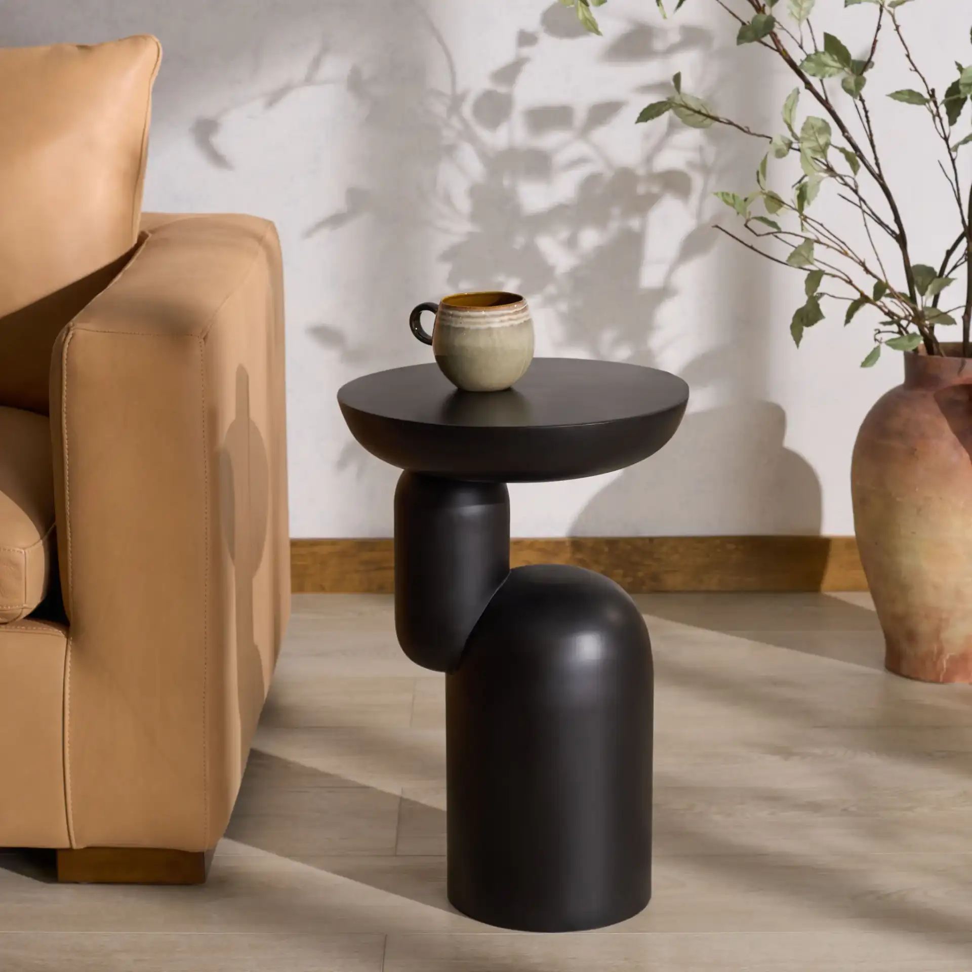 Donnastella Metal Accent Table in Black in a styled room