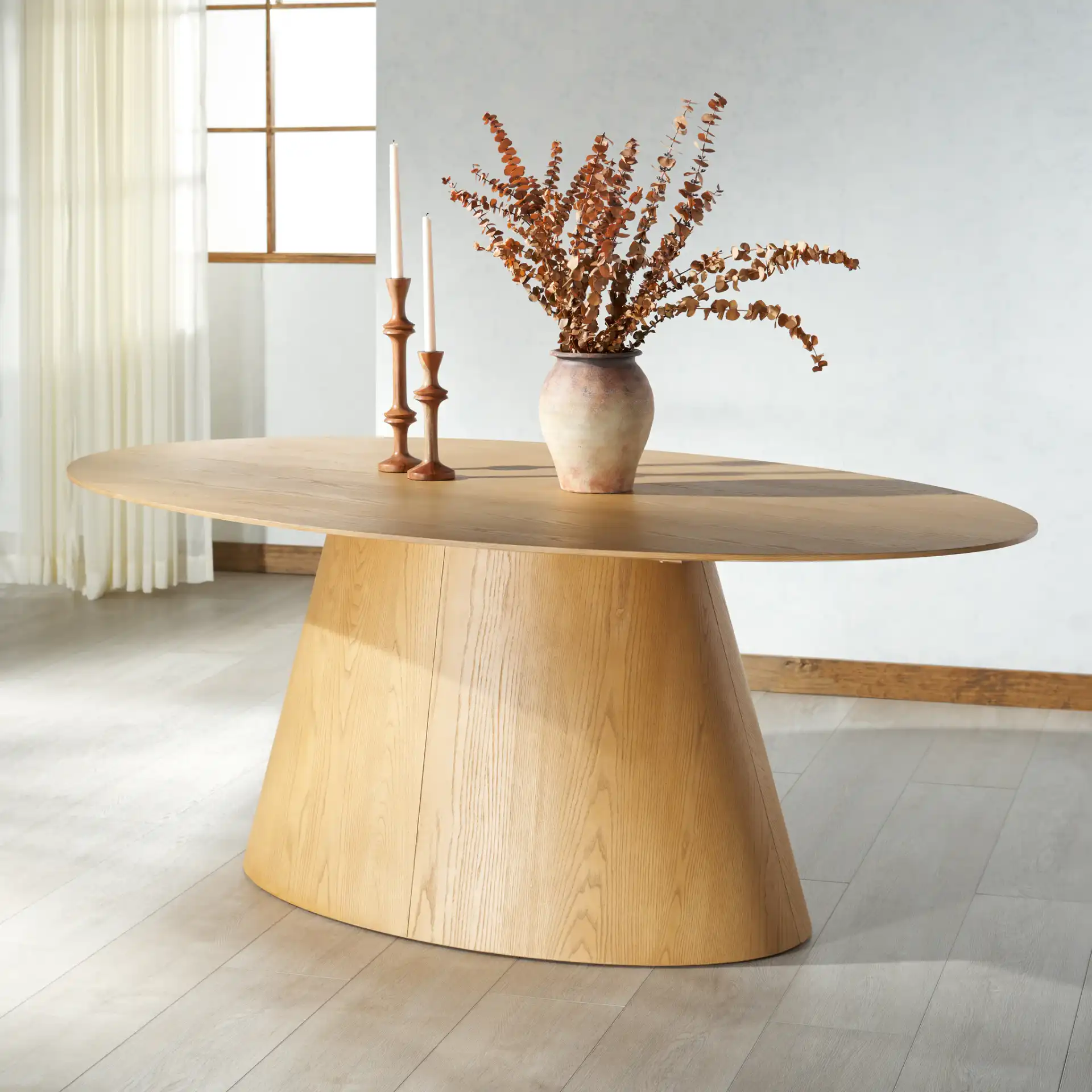 Owyn Oval Wood Dining Table in Natural in a styled room