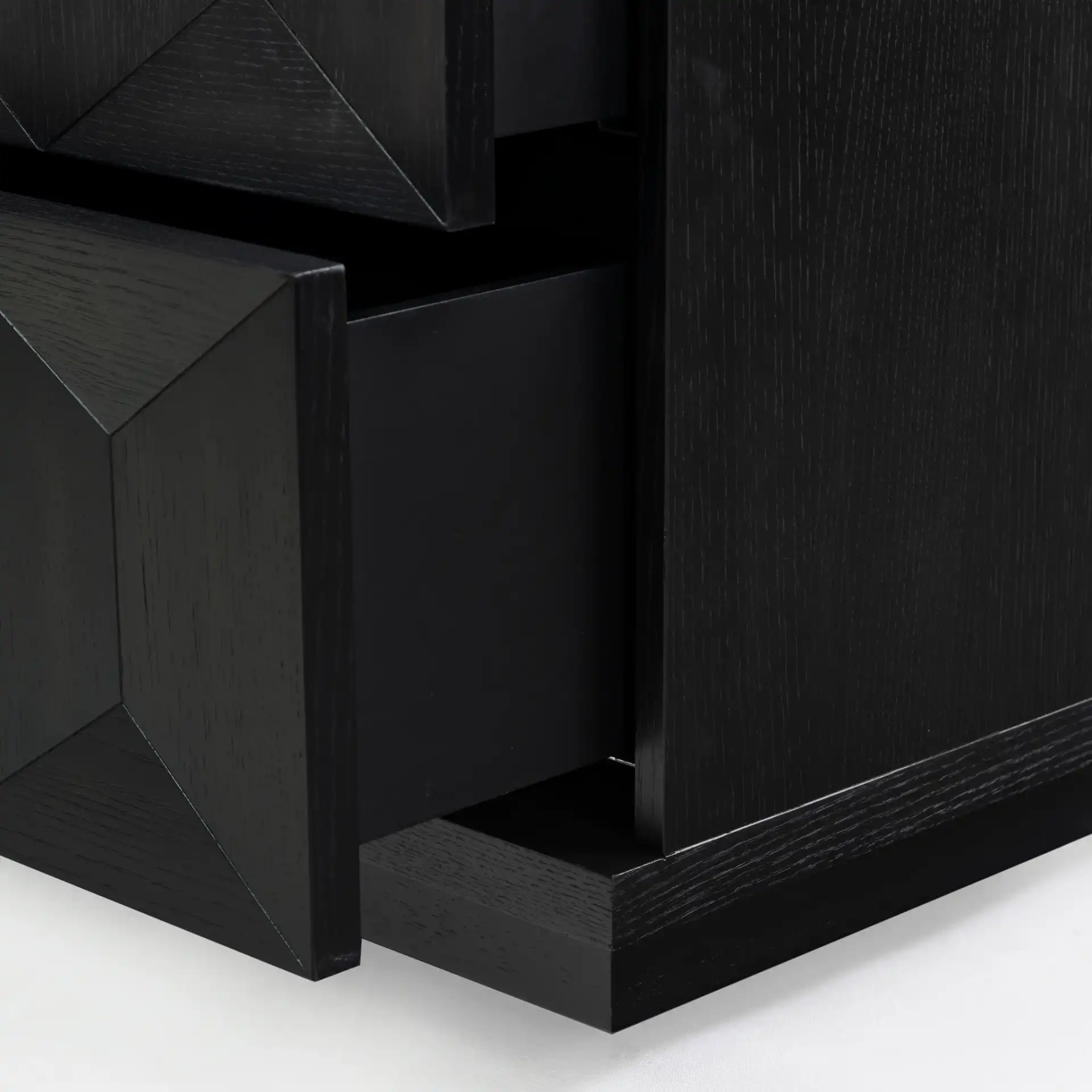 Deziree Wood Two-Drawer Nightstand in Black in a styled room