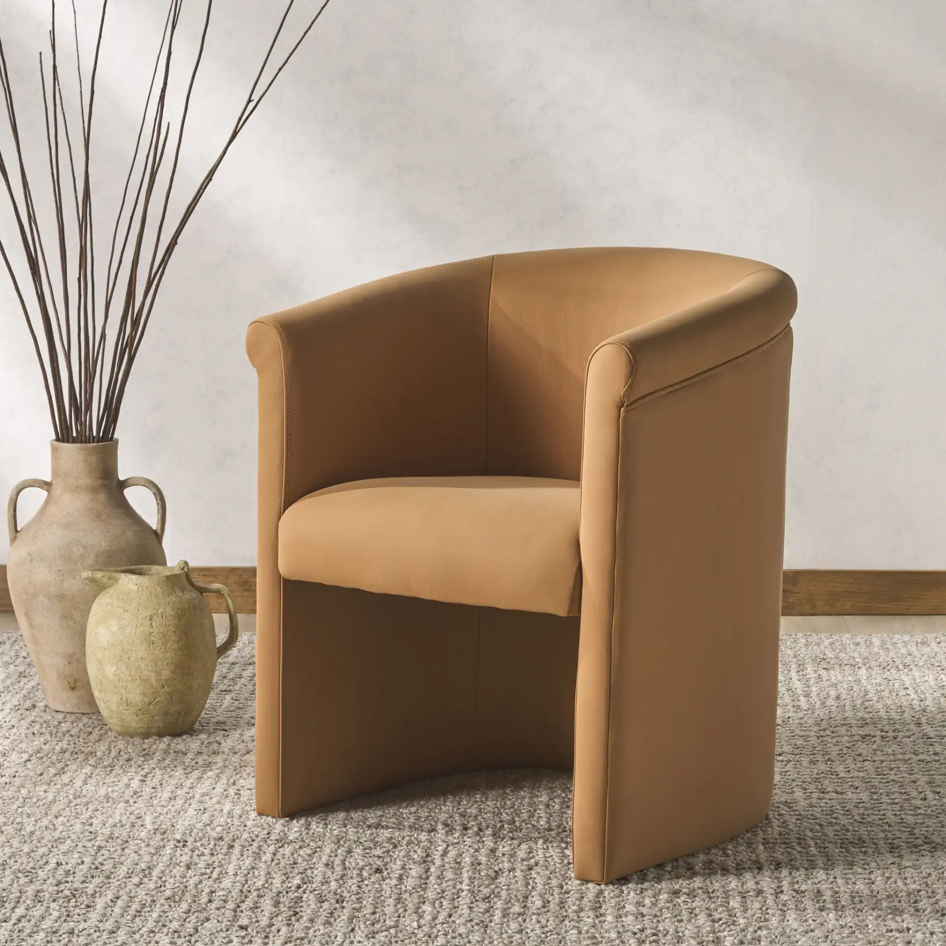 Selina Barrel Back Dining Chair in Brown in a styled room