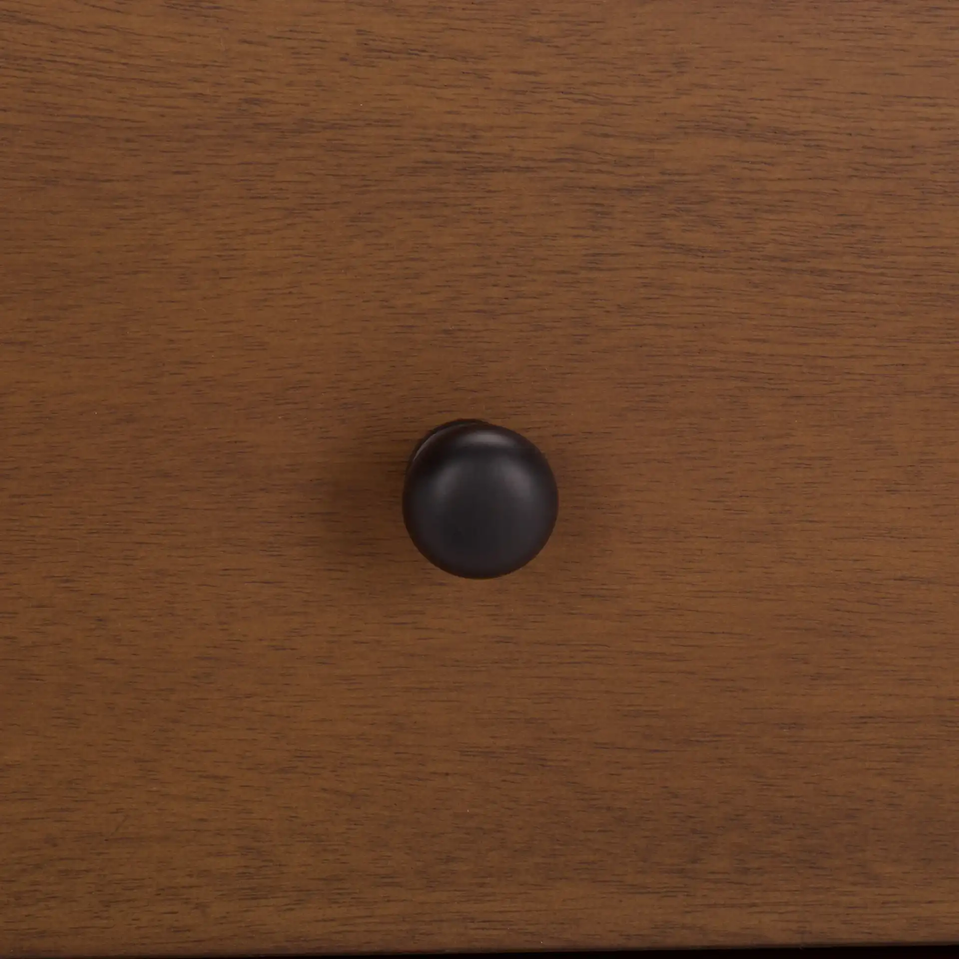 Trever Wood Three-Drawer Nightstand in Walnut / Black in a styled room