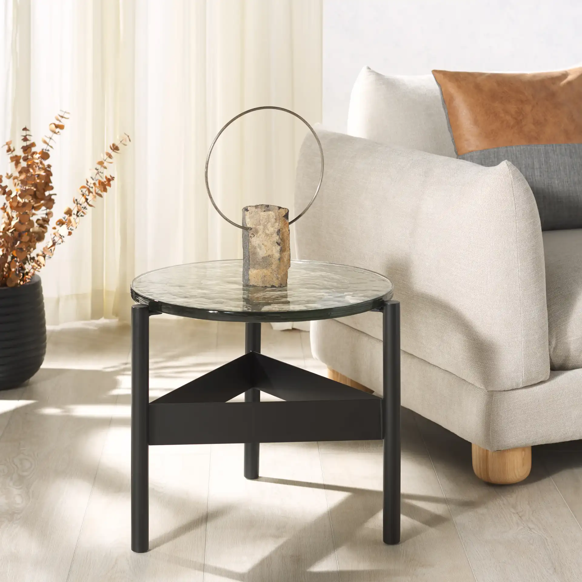 Rozalia Cast Glass Accent Table in Black / Clear in a styled room
