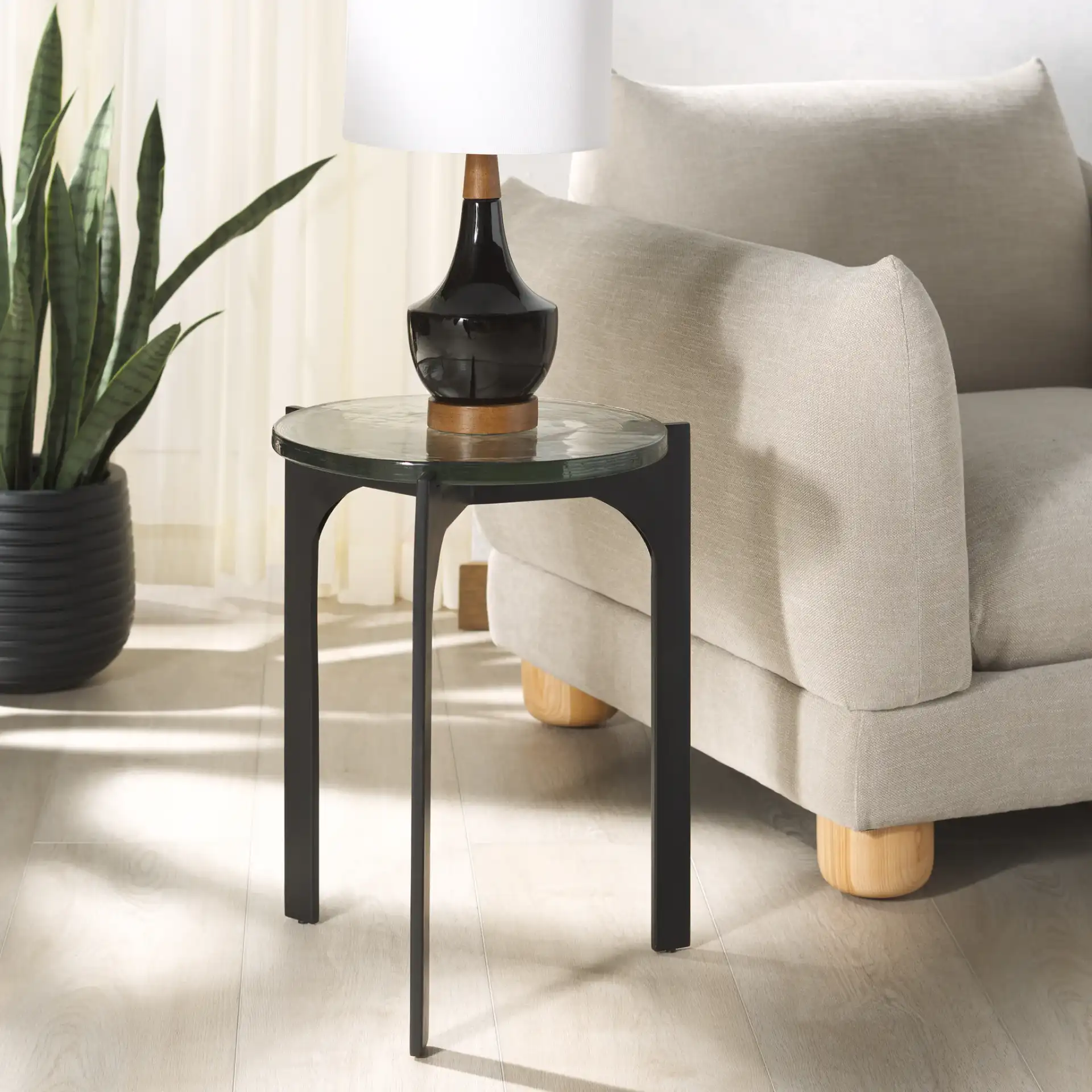 Seymour Cast Glass Accent Table in Black / Clear in a styled room