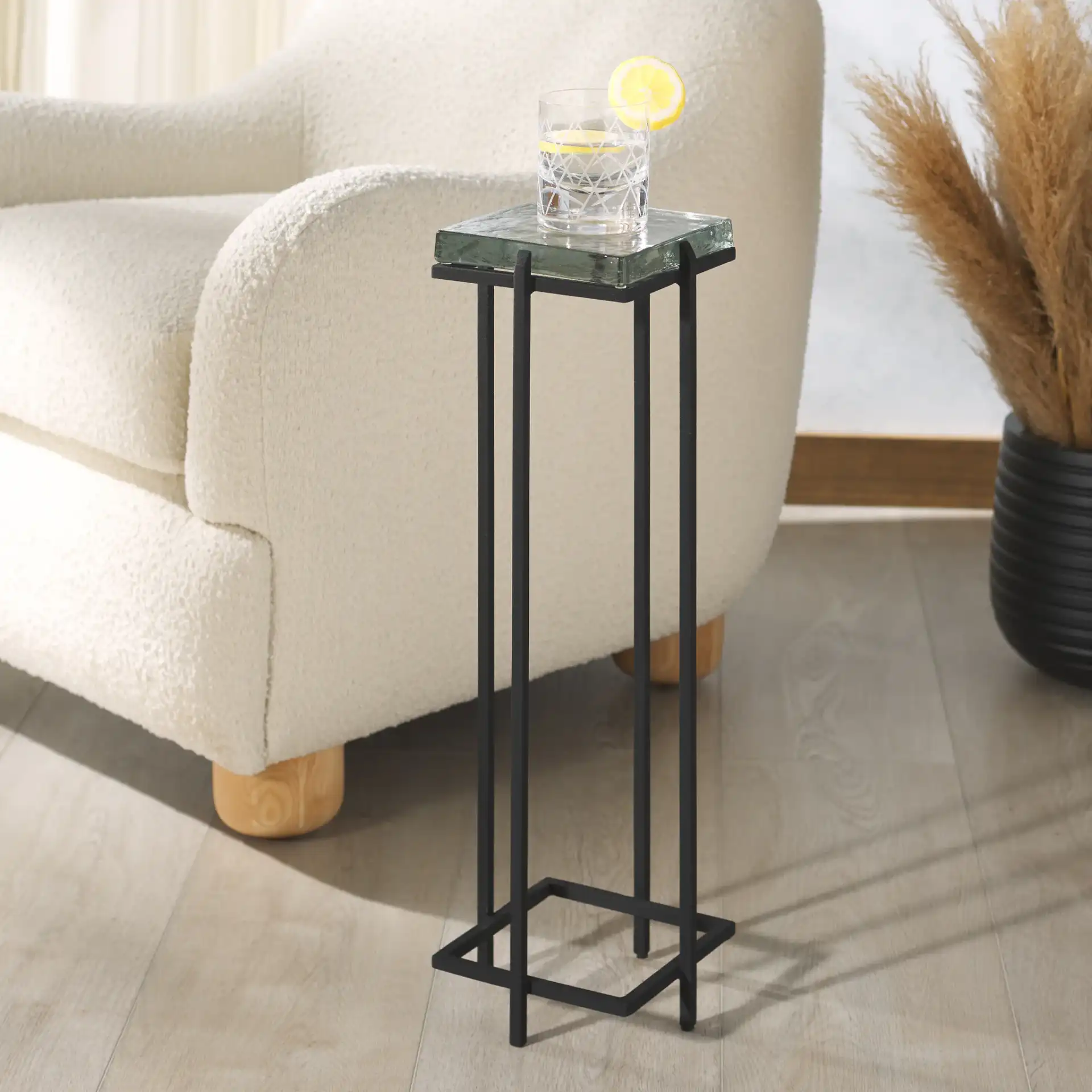 Giabelle Cast Glass Drink Table in Black / Clear in a styled room
