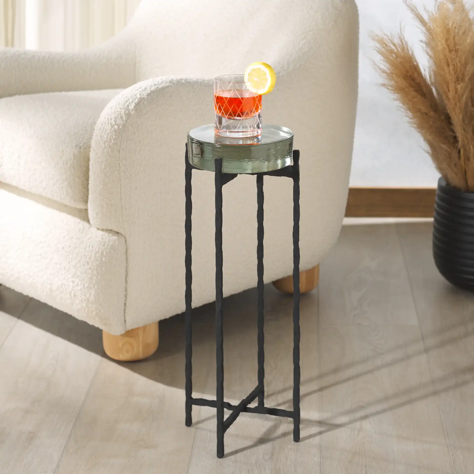 Kathaleen Cast Glass Drink Table in Black / Clear in a styled room