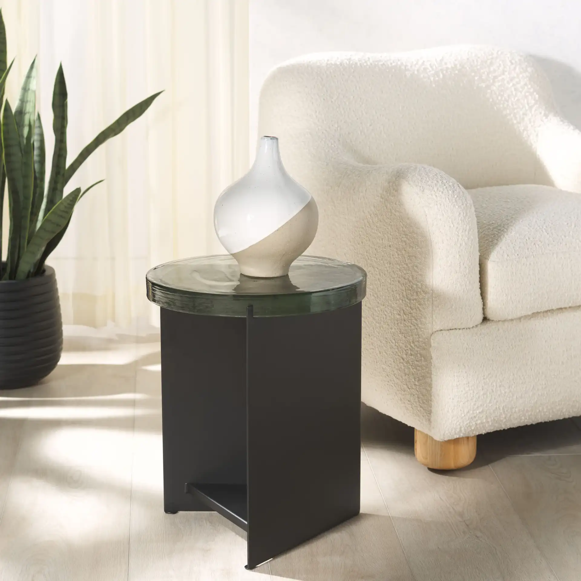 Marisella Cast Glass Accent Table in Black / Clear in a styled room