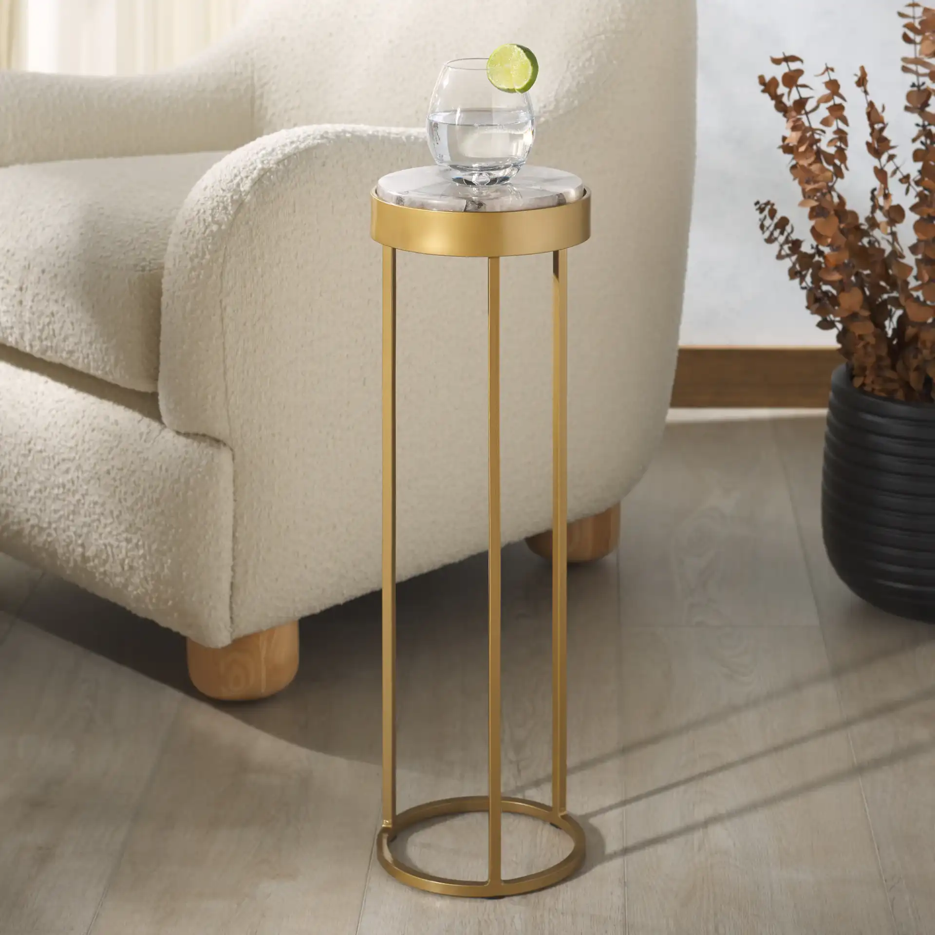 Hannahmarie Stone Drink Table in Gold / White in a styled room