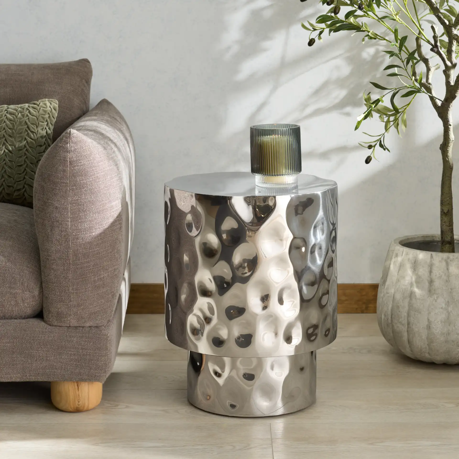 Janalee Steel Accent Table in Charcoal in a styled room