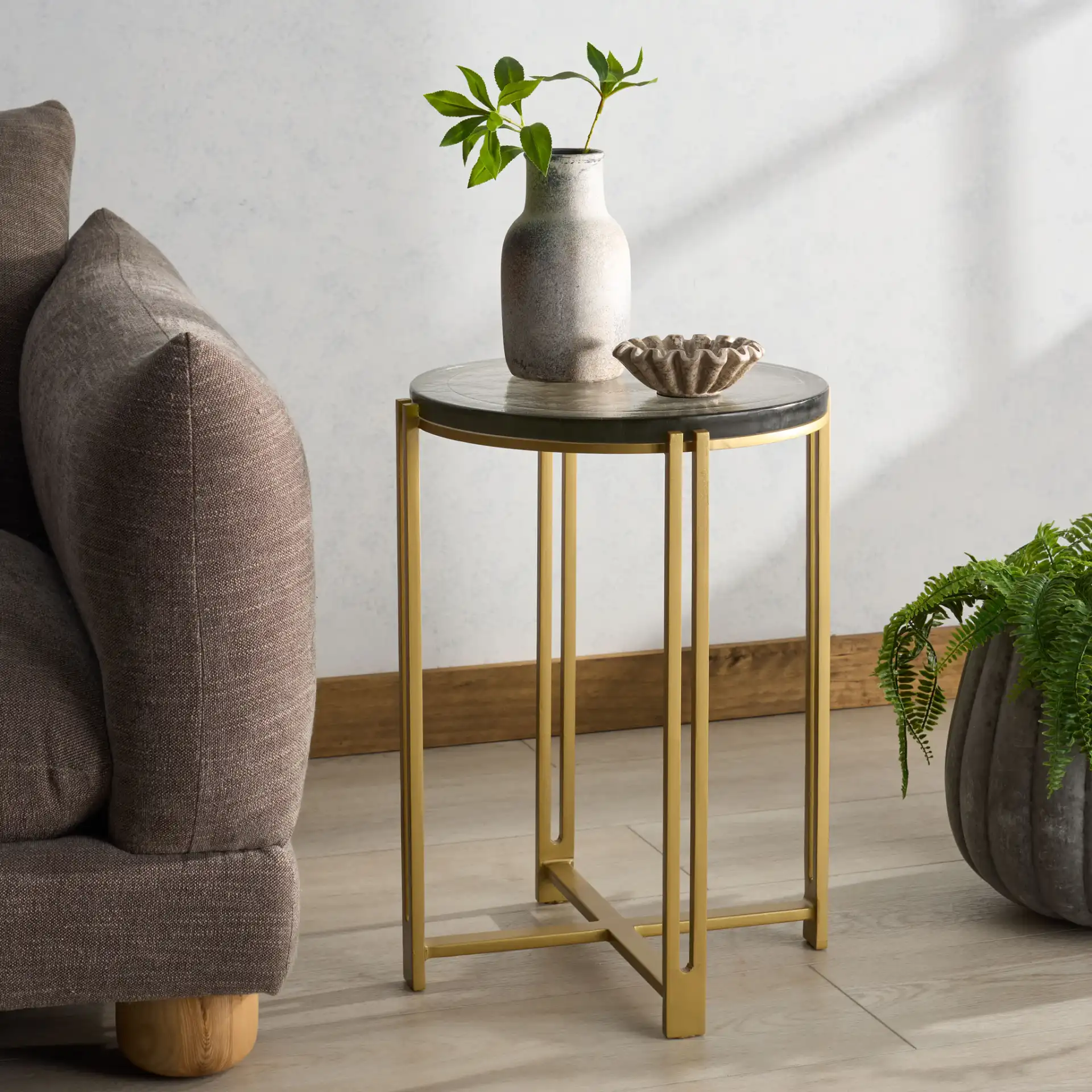 Levitt Cast Glass Top Accent Table in Brass / Clear in a styled room