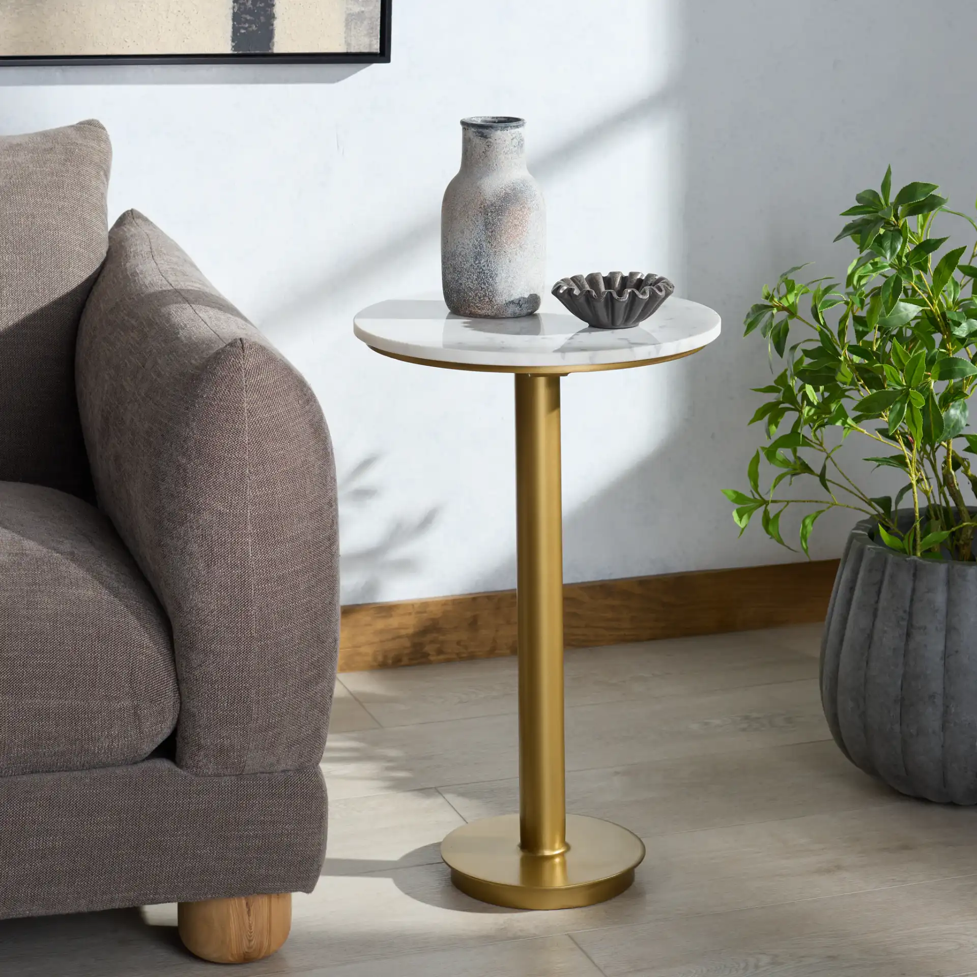 Branxton Marble Top Accent Table in Brass / White in a styled room
